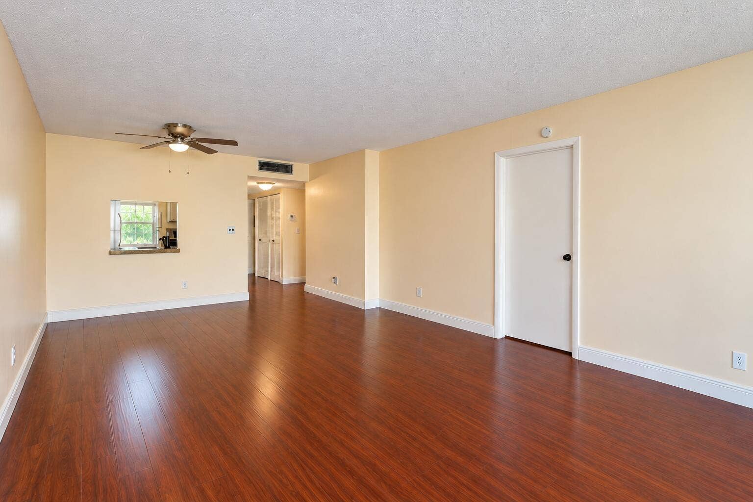 Bright Empty Living Room with Kitchen Pa