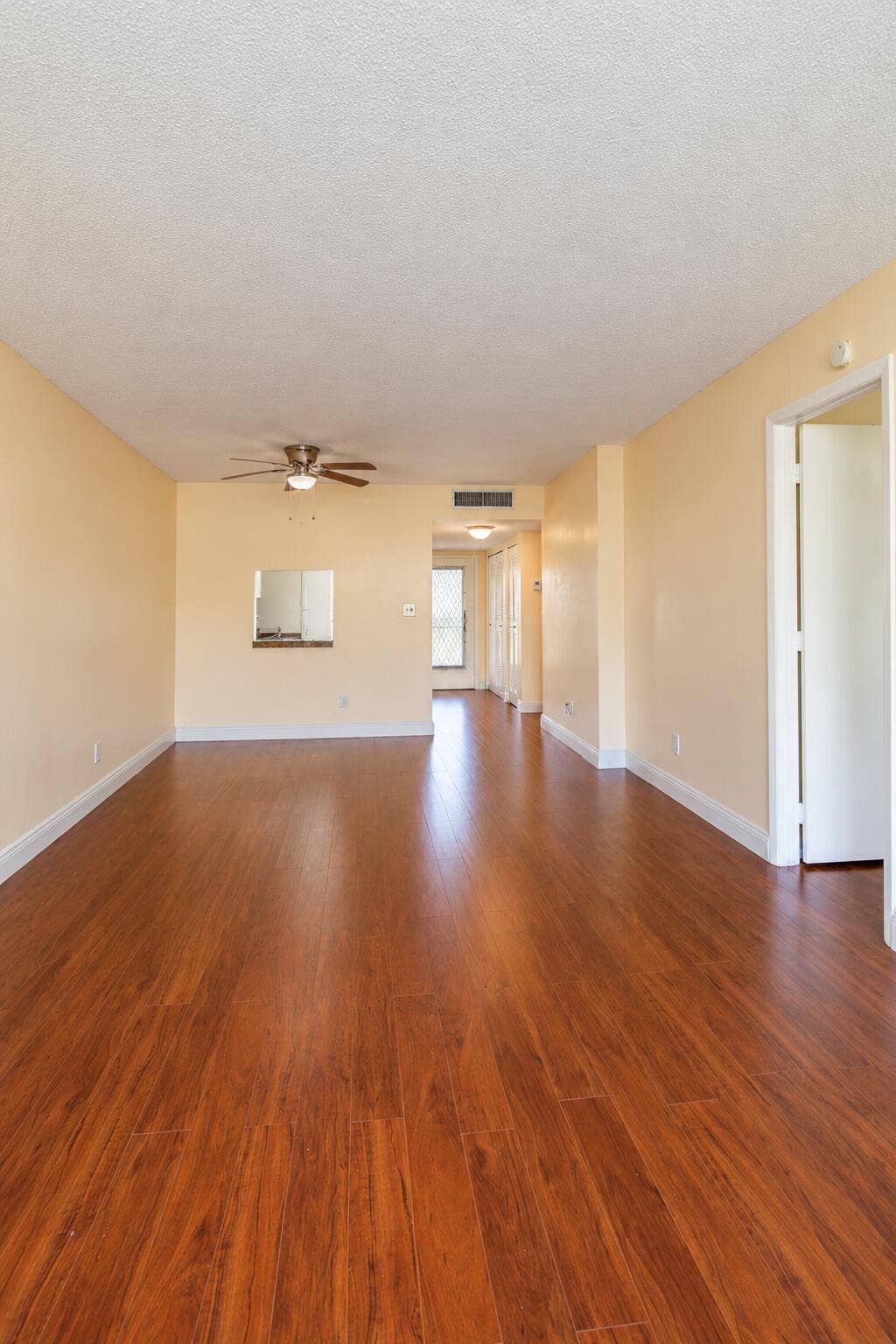 Empty Beige Living Room with Wood Floors