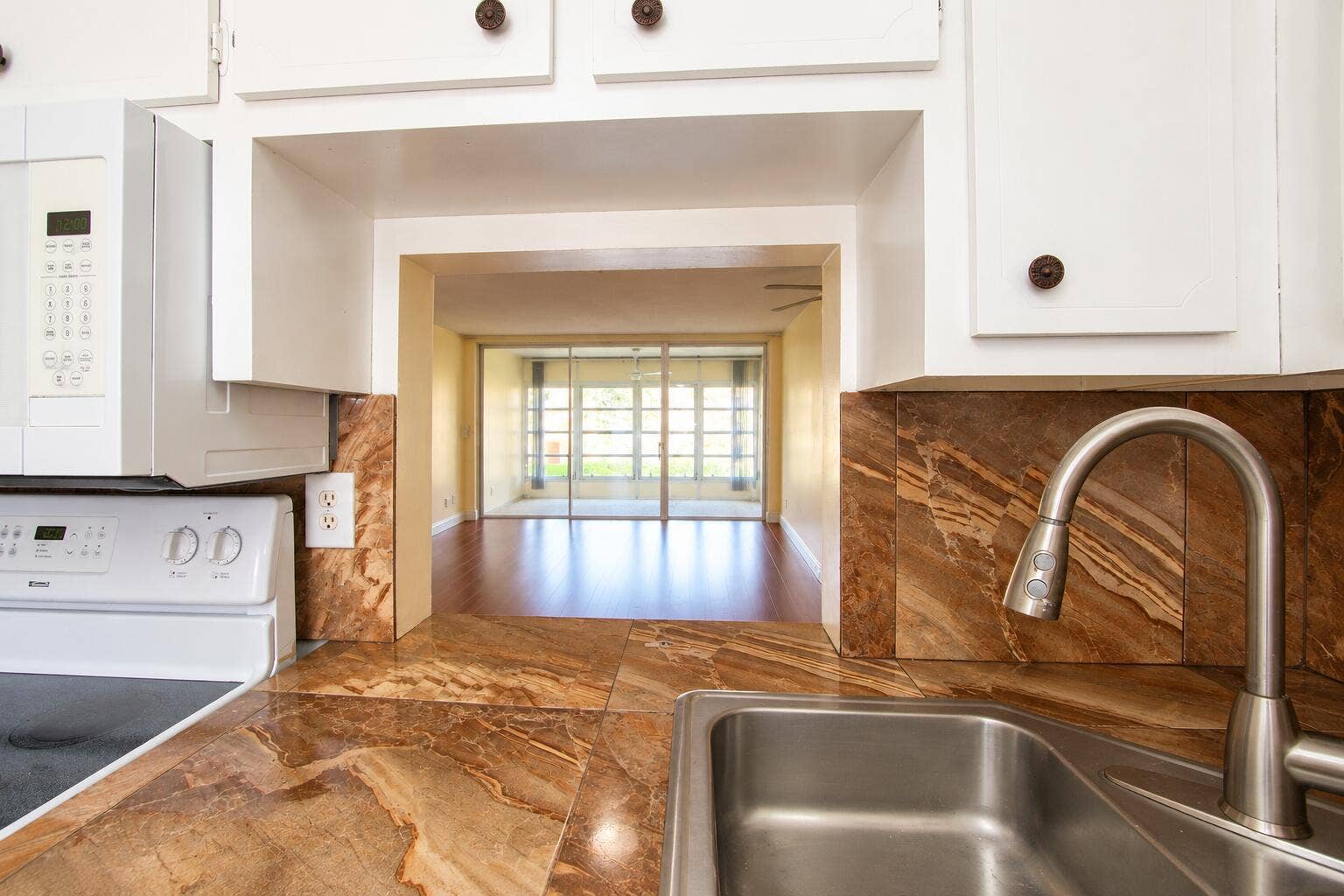 Kitchen Pass-Through to Sunlit Living Ro