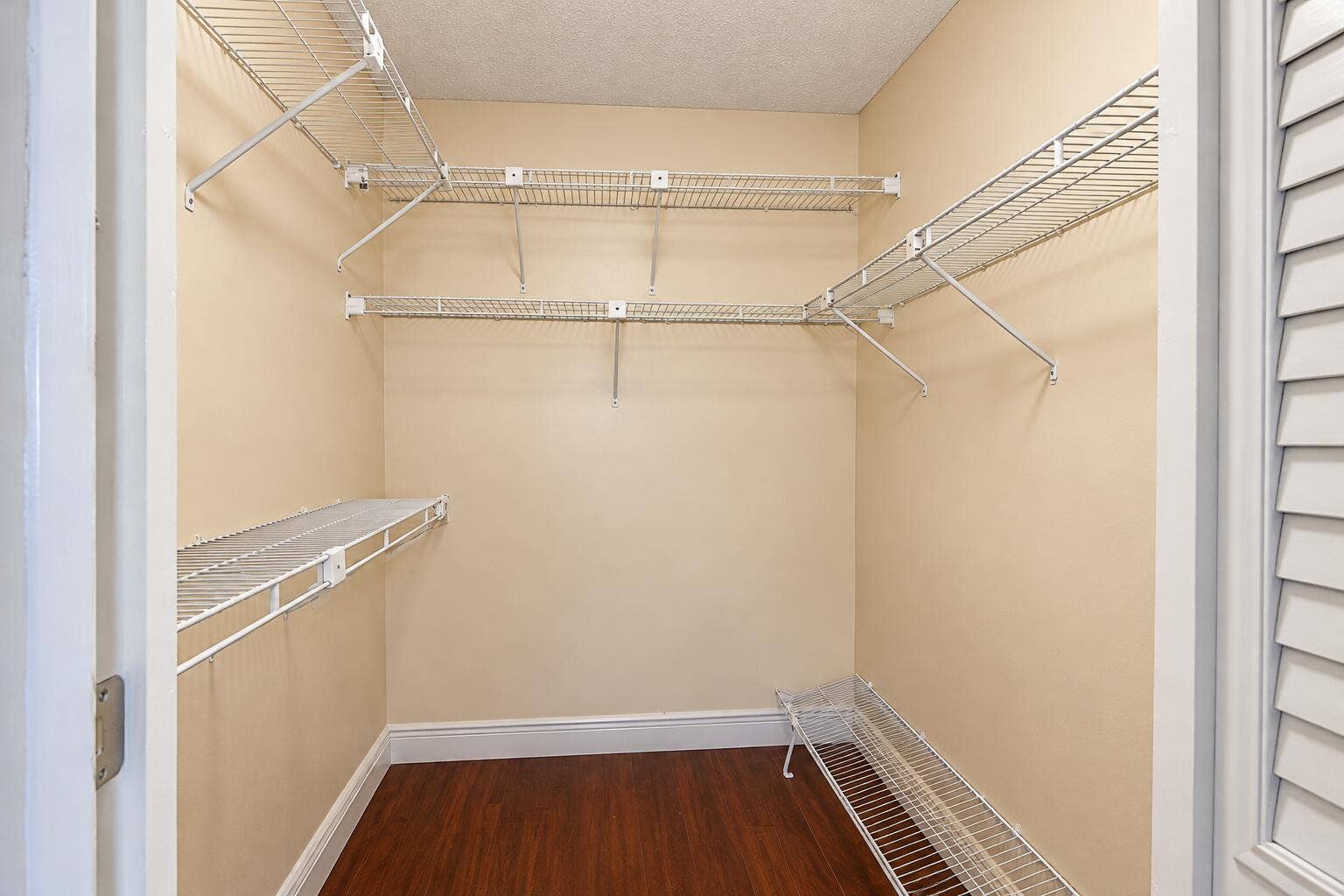 Empty Beige Walk-In Closet with Wire She