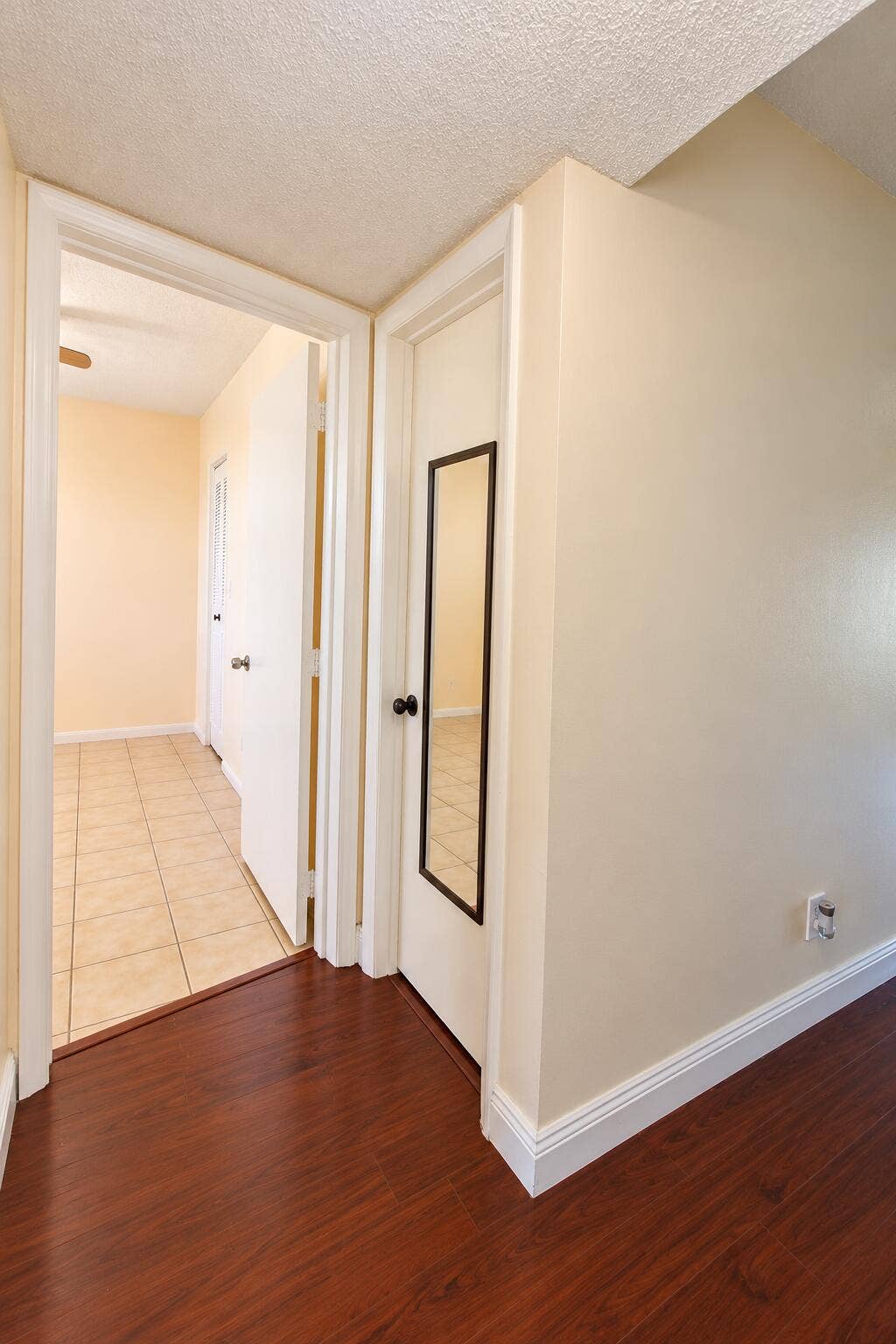 Bright Neutral Hallway with Mirrored Doo