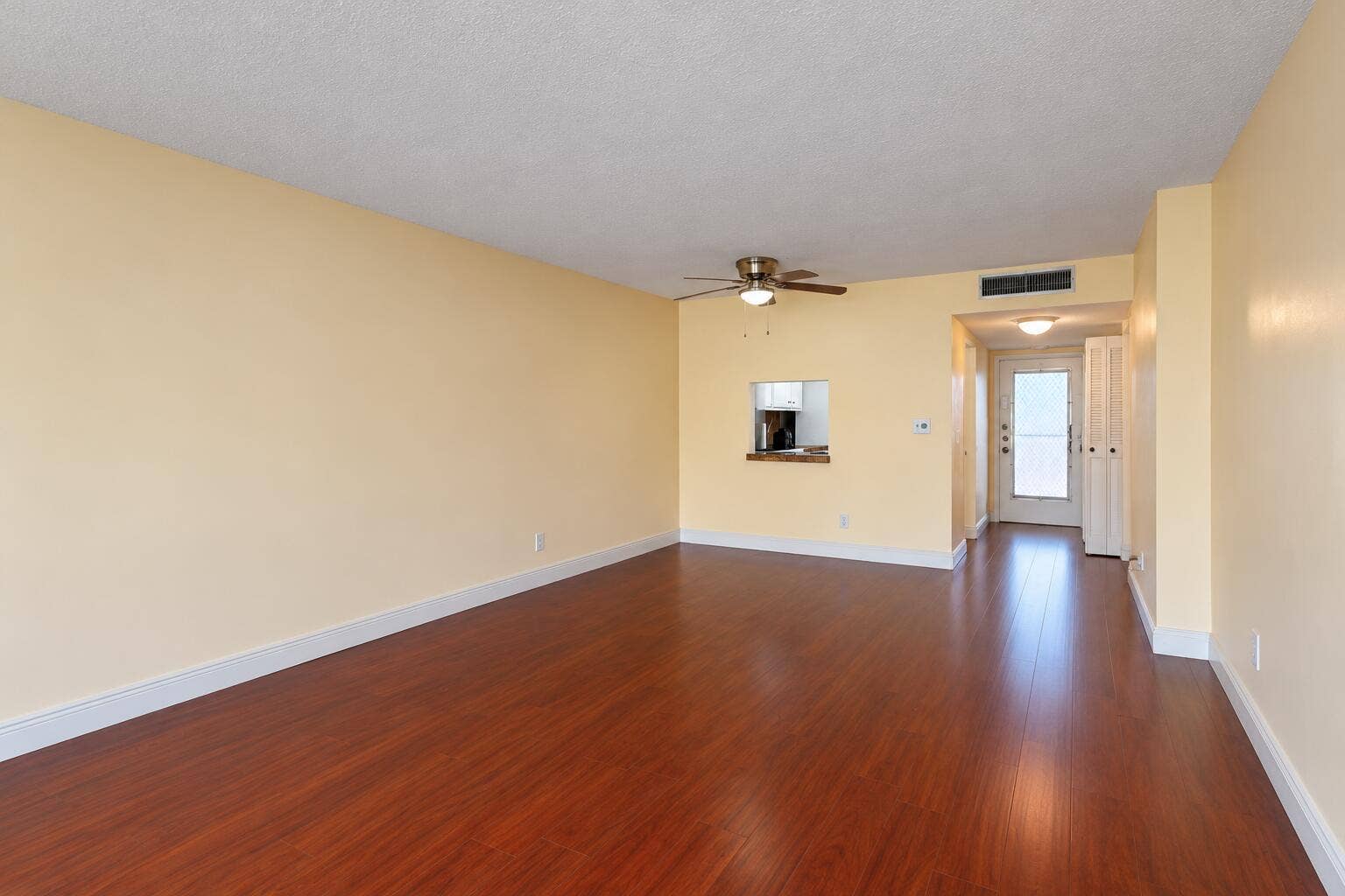 Bright Empty Living Room with Kitchen Pa
