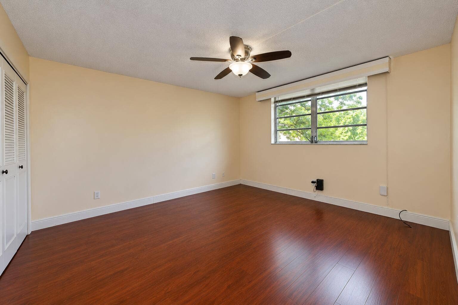 Bright Empty Room with Ceiling Fan and W