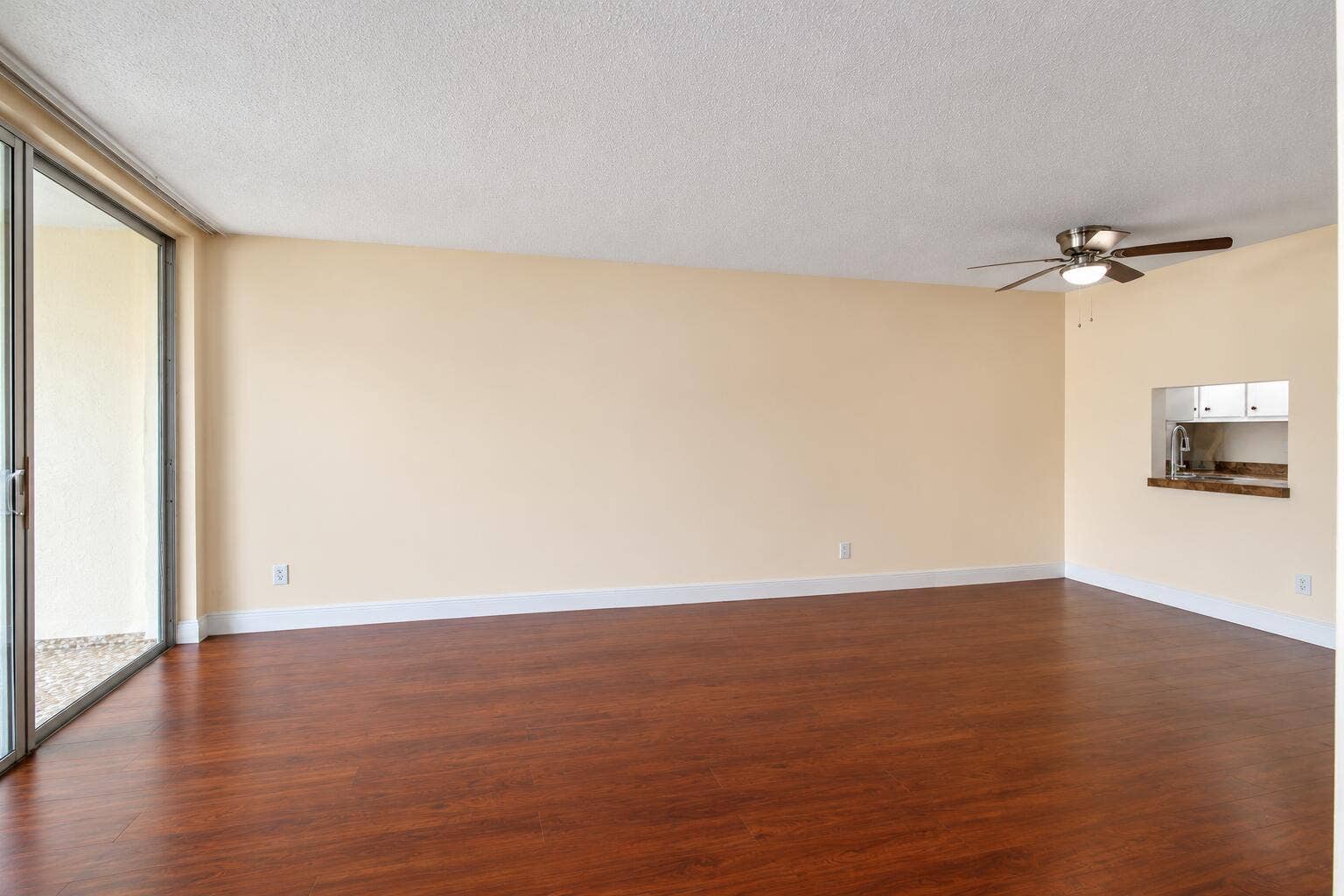 Bright Empty Living Room with Kitchen Pa