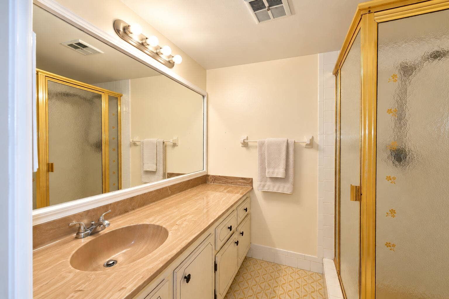Bright Retro Bathroom with Brass Shower