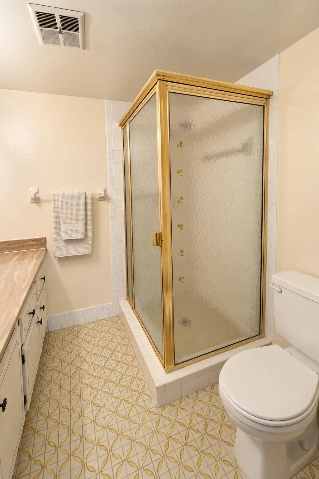 Retro Cream Bathroom with Gold-Framed Sh