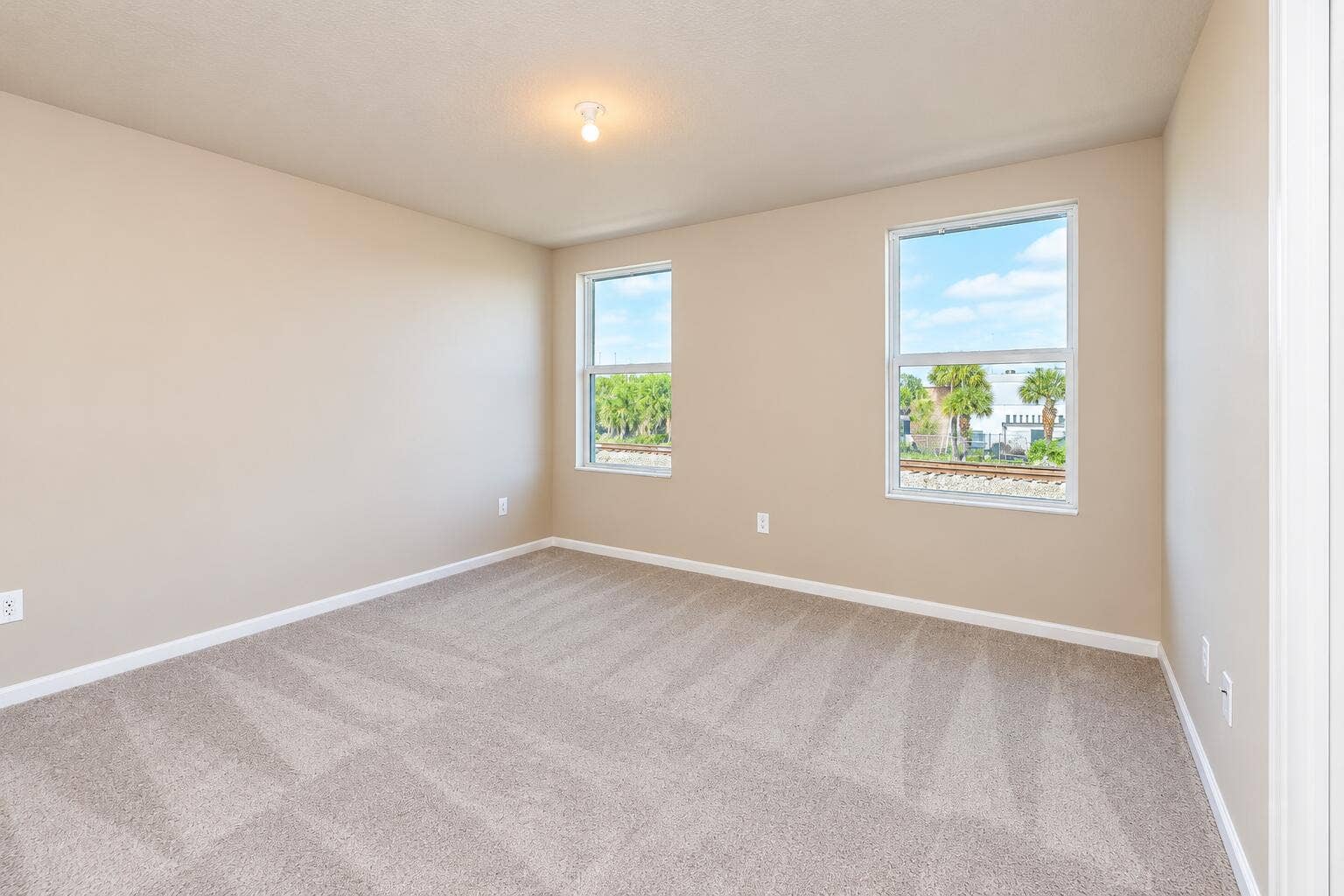 Empty Neutral Bedroom with Sunny Windows