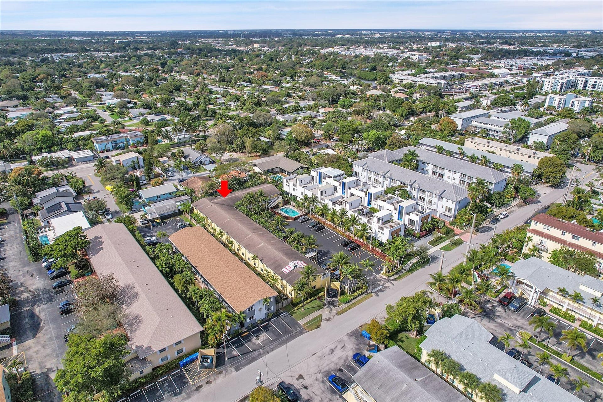 2655 NE 8th Avenue, #Apt 210, Wilton Manors, FL 33334 Aerial perspective showcasing the property's location within a residential neighborhood with ample foliage