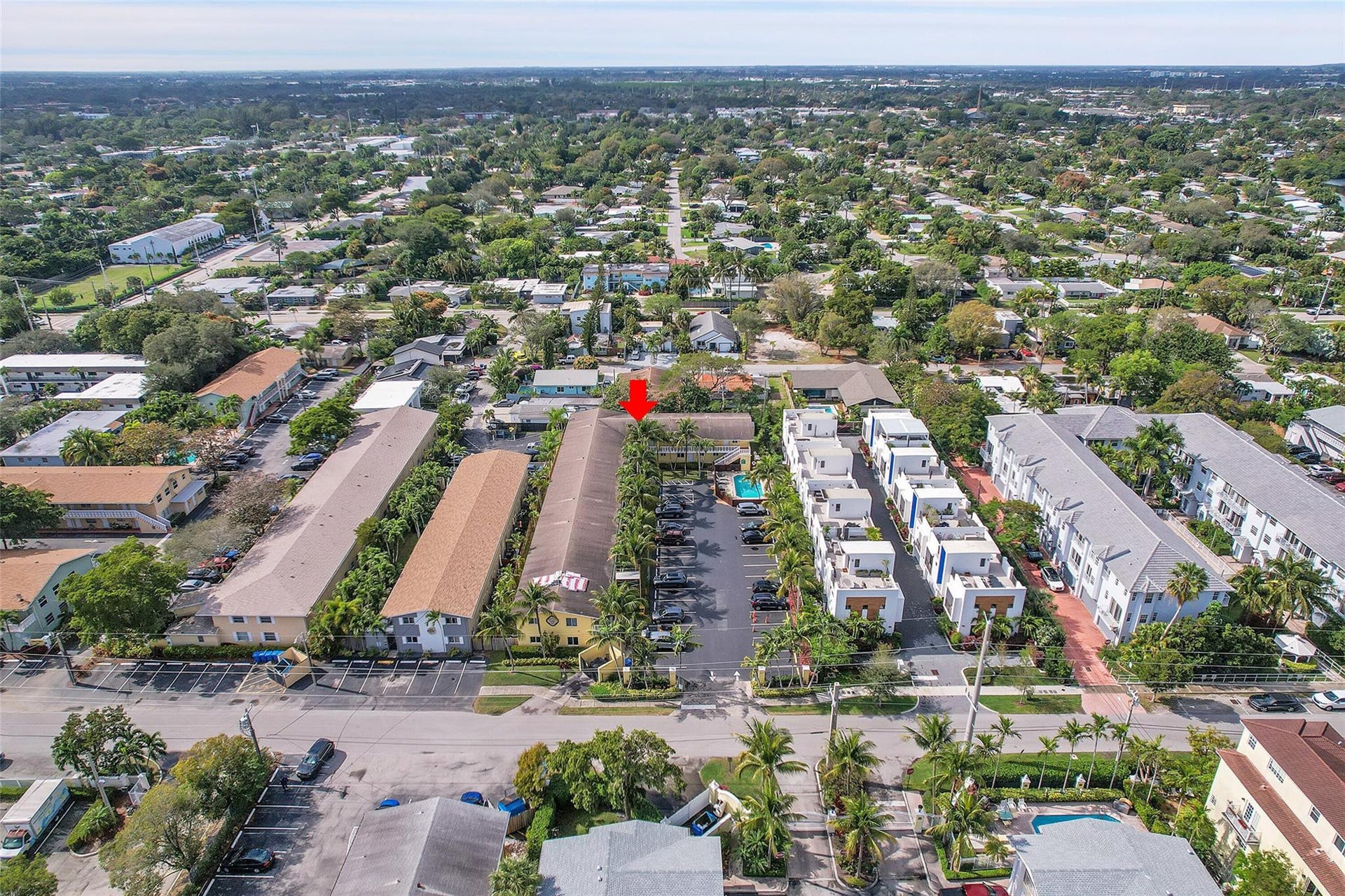 2655 NE 8th Avenue, #Apt 210, Wilton Manors, FL 33334 Aerial perspective of a developed neighborhood featuring residential structures, mature trees, and paved roadways