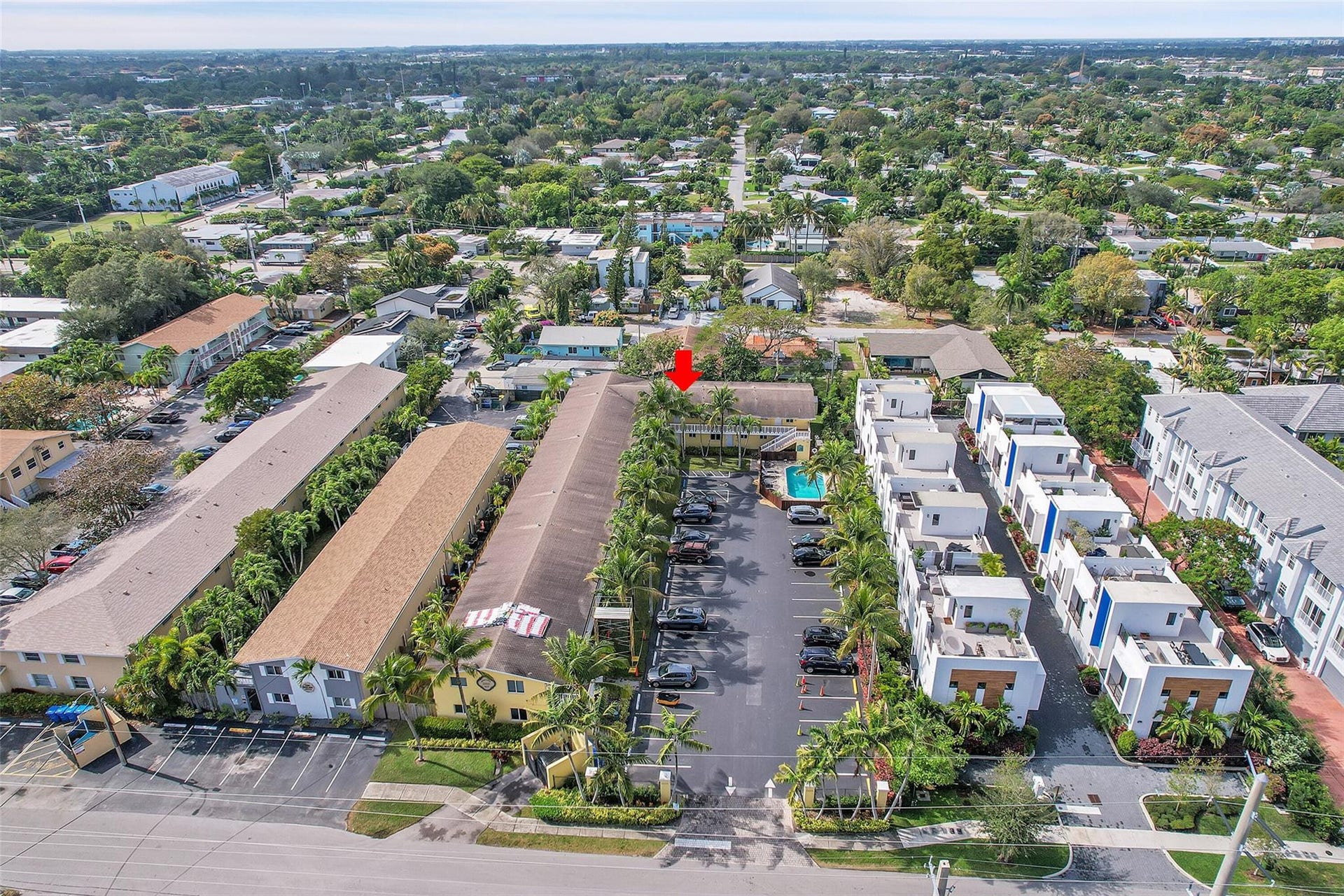 2655 NE 8th Avenue, #Apt 210, Wilton Manors, FL 33334 Residential community featuring multiple buildings, surface parking, and a central swimming pool