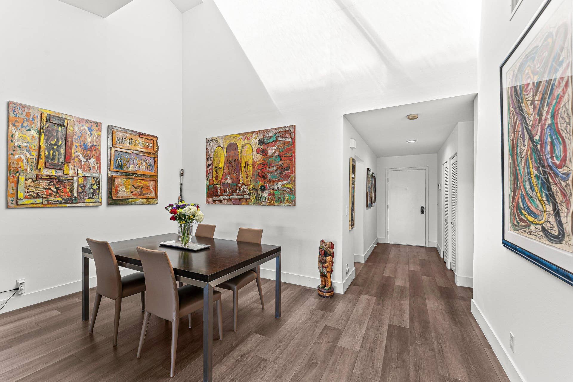 Vaulted ceiling, wood-finish flooring, recessed lighting, white walls, white doors