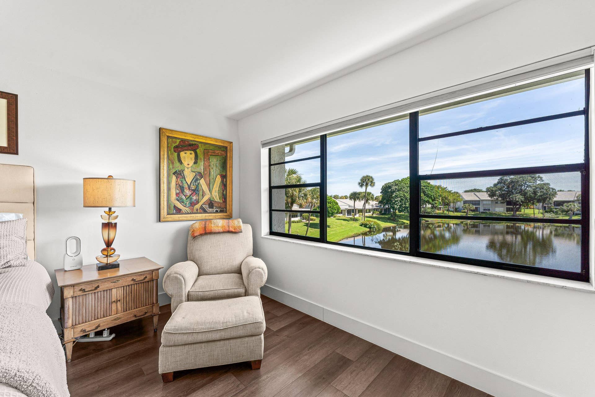 Expansive multi-pane window, wood-finish flooring, white walls, and bright overhead lighting