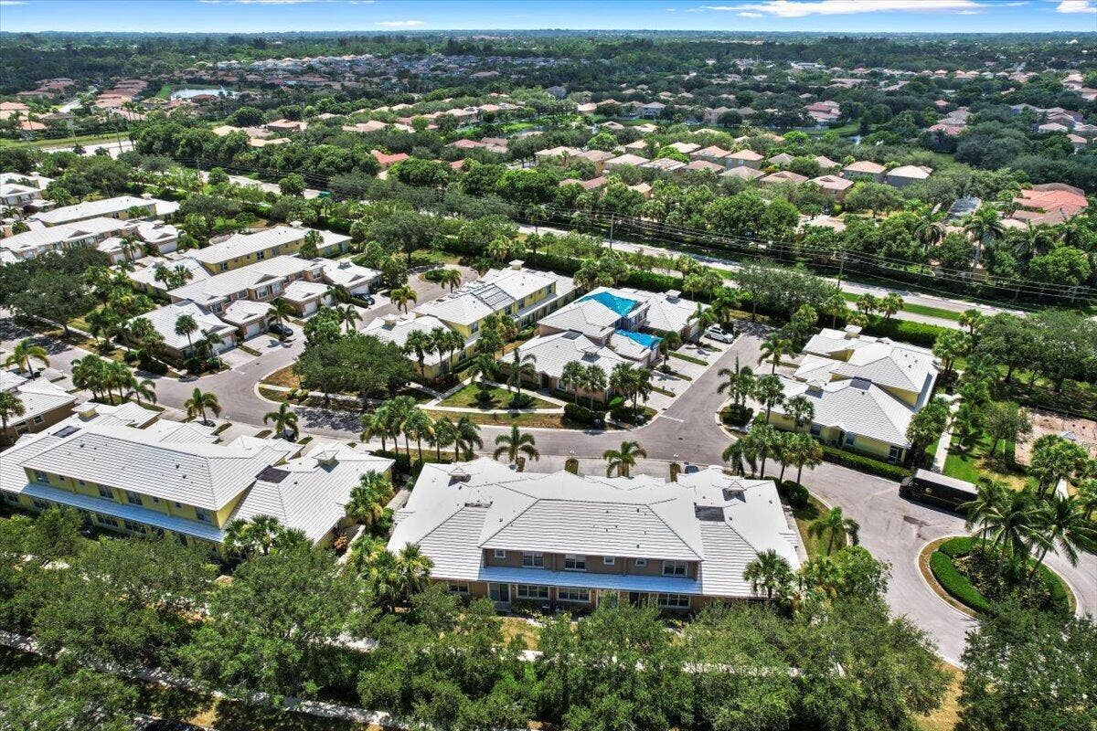 Wide aerial view of the neighborhood featuring residential streets and nearby green spaces.