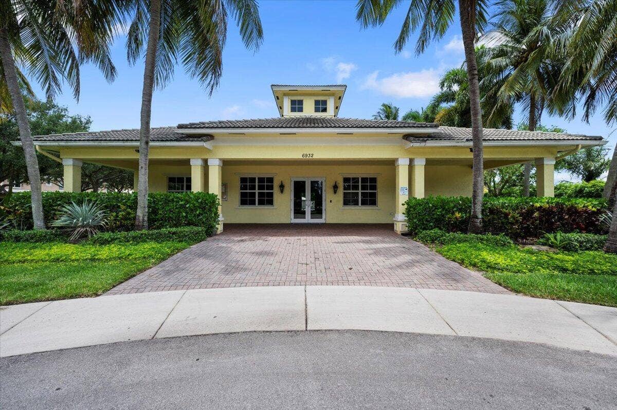 Lantern Key clubhouse surrounded by palm trees and beautifully maintained landscaping.
