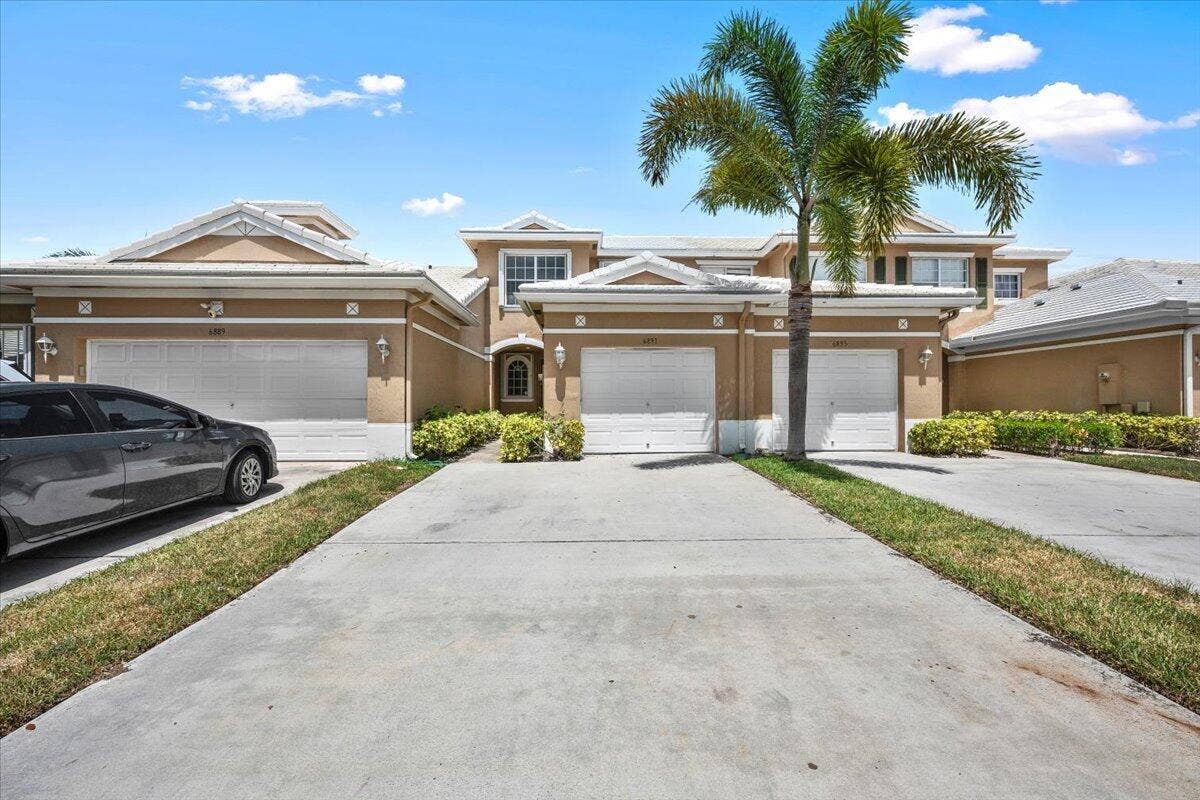 Attractive two-story townhome with an attached garage and welcoming entrance.
