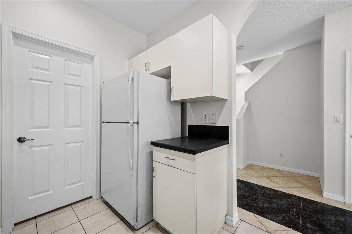 White cabinetry, dark countertops, and a convenient layout.