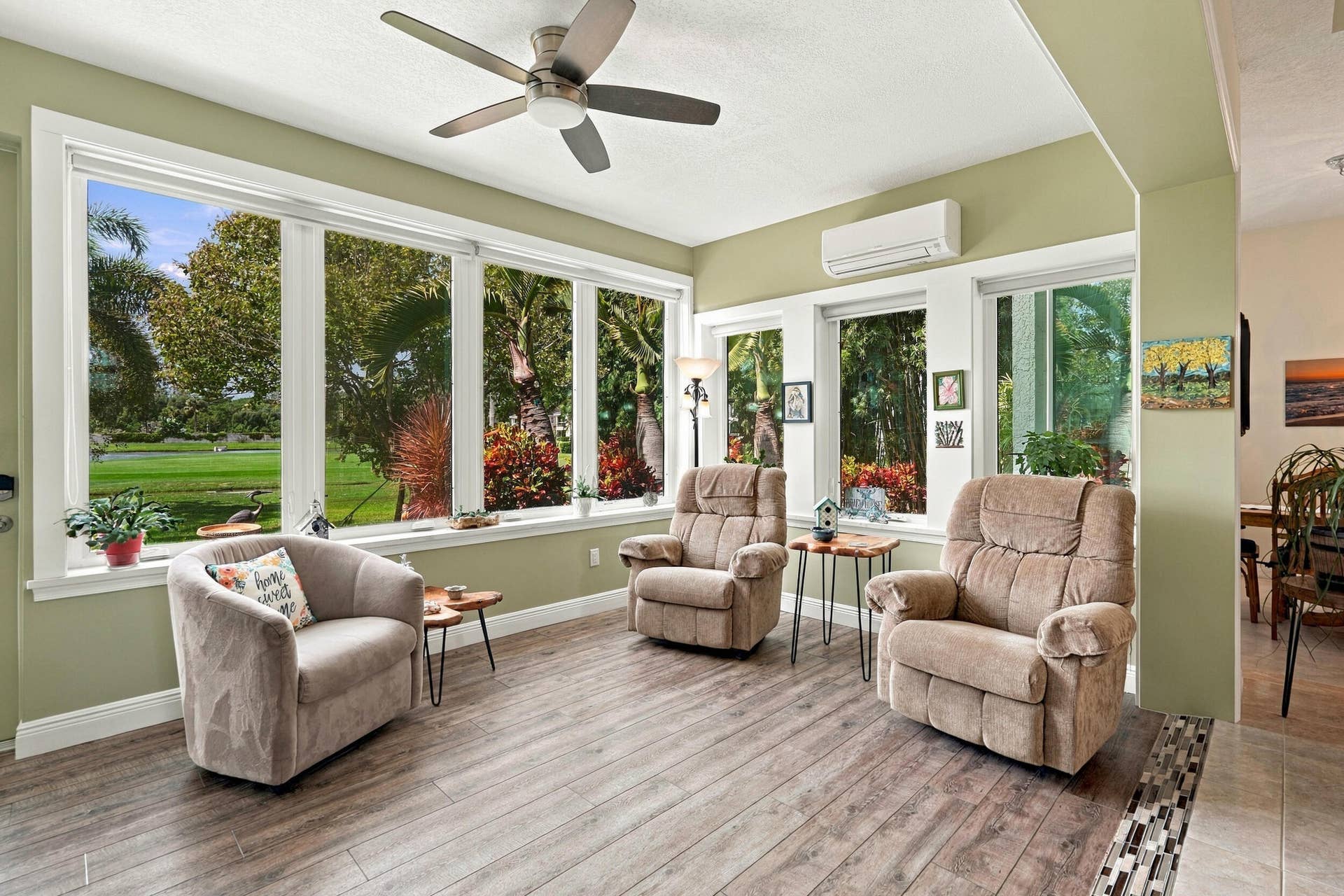 91 Southpointe Drive, Fort Pierce, FL 34949 The enclosed sunroom features a wall of impact windows. Enjoy beautiful sunsets, watching golfers, and enjoying morning coffee or an evening cocktail.