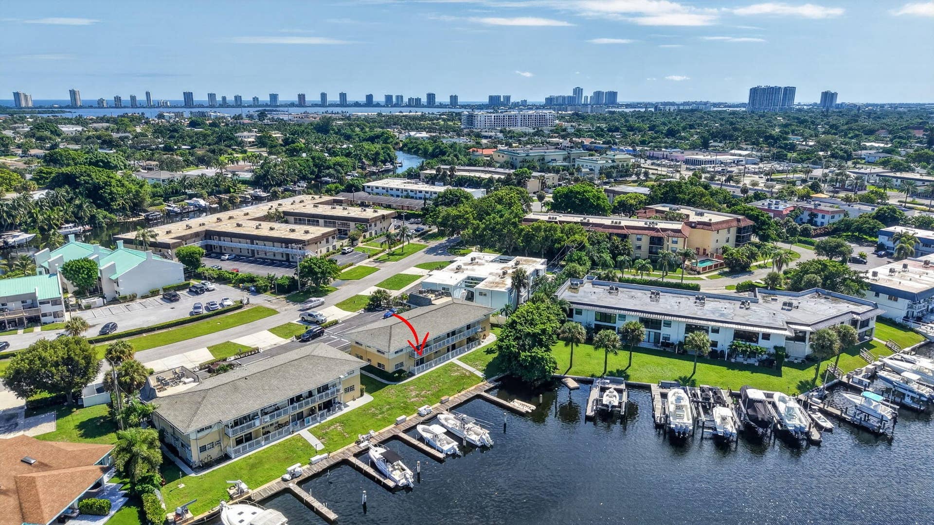 405 SOUTHWIND Drive, #3, North Palm Beach, FL 33408 Aerial perspective of waterfront property featuring boat docks, canal access, and multi-level building architecture