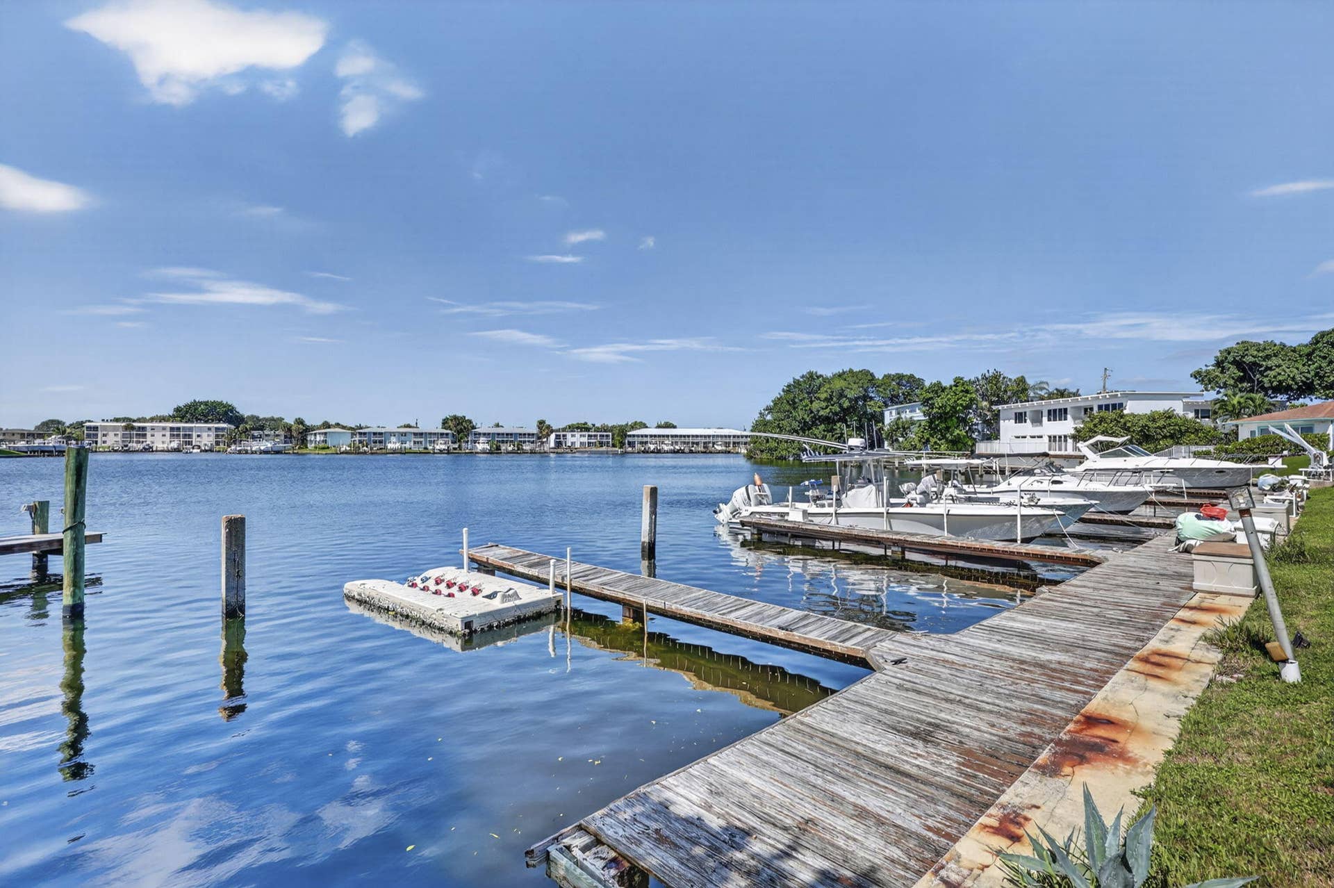 405 SOUTHWIND Drive, #3, North Palm Beach, FL 33408 Waterfront property featuring a wooden boat dock, floating platform, and direct water access