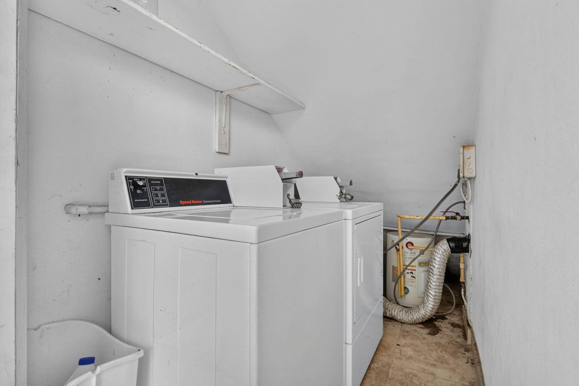 405 SOUTHWIND Drive, #3, North Palm Beach, FL 33408 Laundry area featuring built-in shelving, white walls, and dedicated washer and dryer hookups
