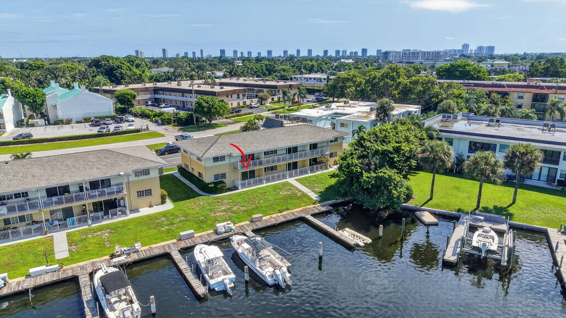 405 SOUTHWIND Drive, #3, North Palm Beach, FL 33408 Multi-story residential building featuring private balcony access, manicured green space, and direct deep-water dockage