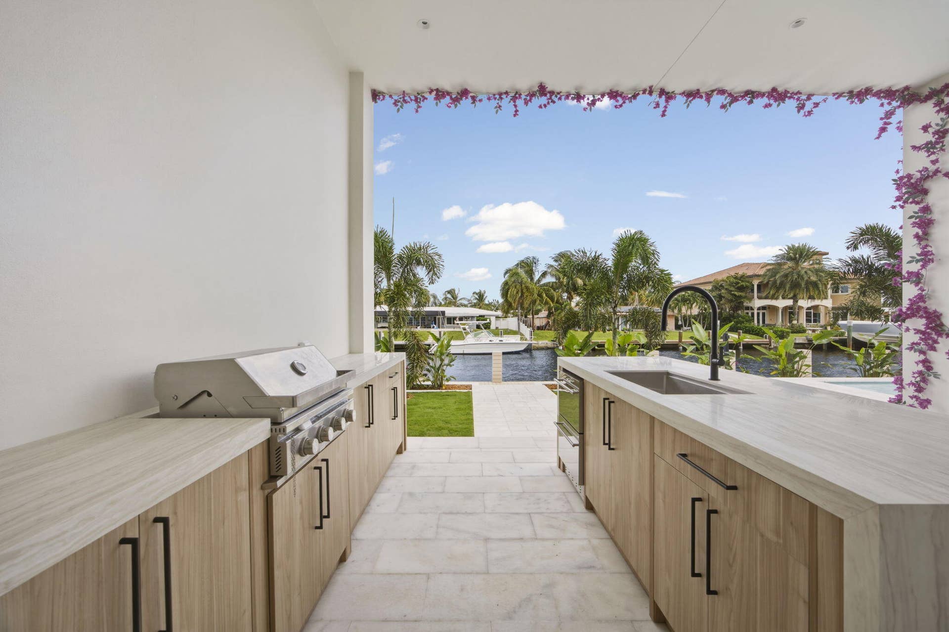 2921 NE 23RD Street, Pompano Beach, FL 33062 Outdoor cabinetry with Neolith Countertops and waterfall gas grill, fridge