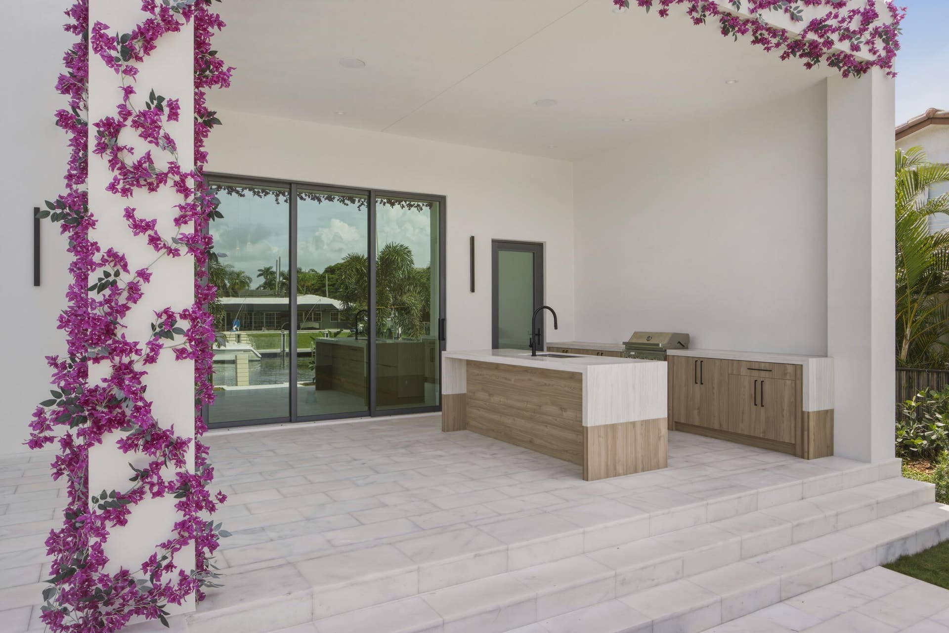 2921 NE 23RD Street, Pompano Beach, FL 33062 Outdoor cabinetry with Neolith Countertops and waterfall gas grill, fridge