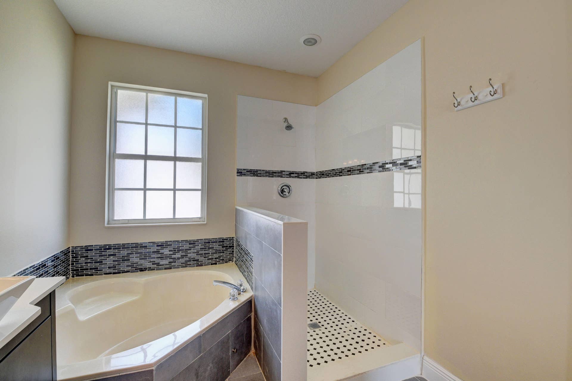 4353 Legacy Court, Delray Beach, FL 33445 Bathroom with corner soaking tub, walk-in shower and window.