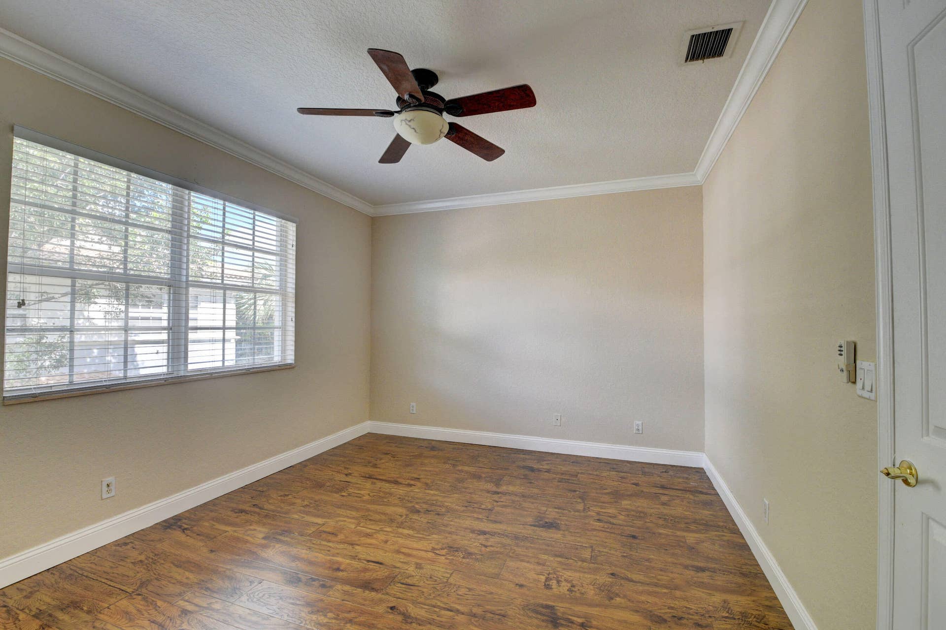 4353 Legacy Court, Delray Beach, FL 33445 Bedroom with ceiling fan, large windows and wood-look flooring.