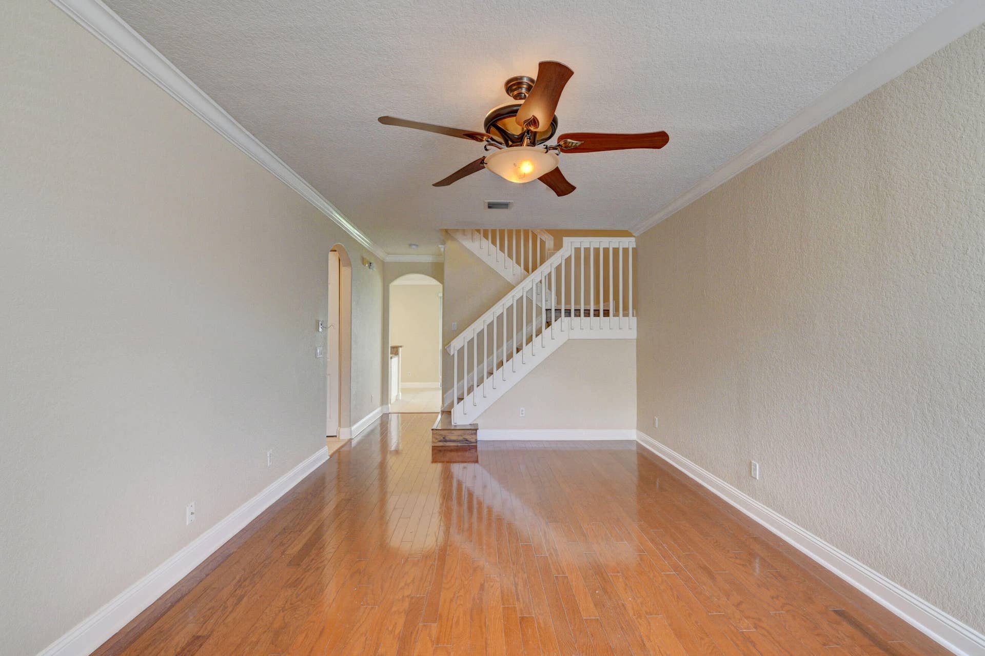 4353 Legacy Court, Delray Beach, FL 33445 Living and dining space with wood-look flooring and staircase to the second floor.