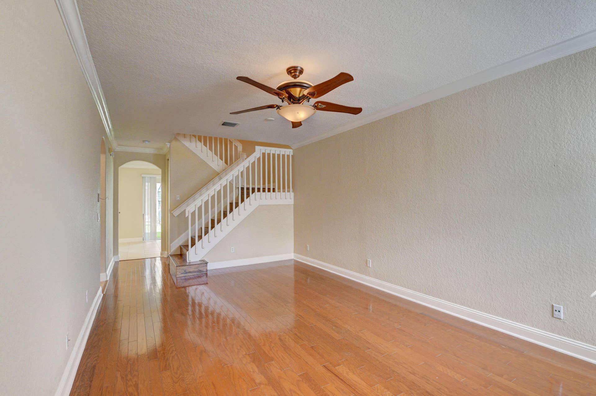 4353 Legacy Court, Delray Beach, FL 33445 Another view of the living space with ceiling fan, crown molding and staircase.