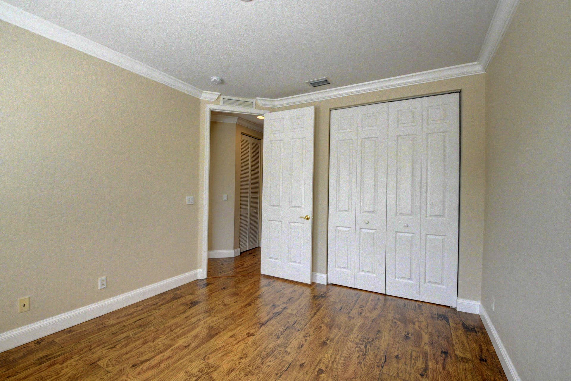 4353 Legacy Court, Delray Beach, FL 33445 Bedroom with double-door closet and wood-look flooring.
