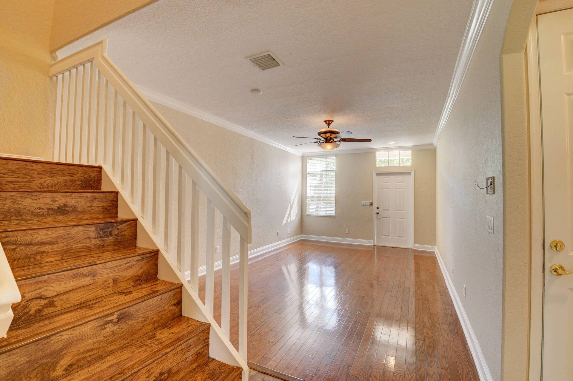 4353 Legacy Court, Delray Beach, FL 33445 Wood stairs with white spindles leading to the second floor.