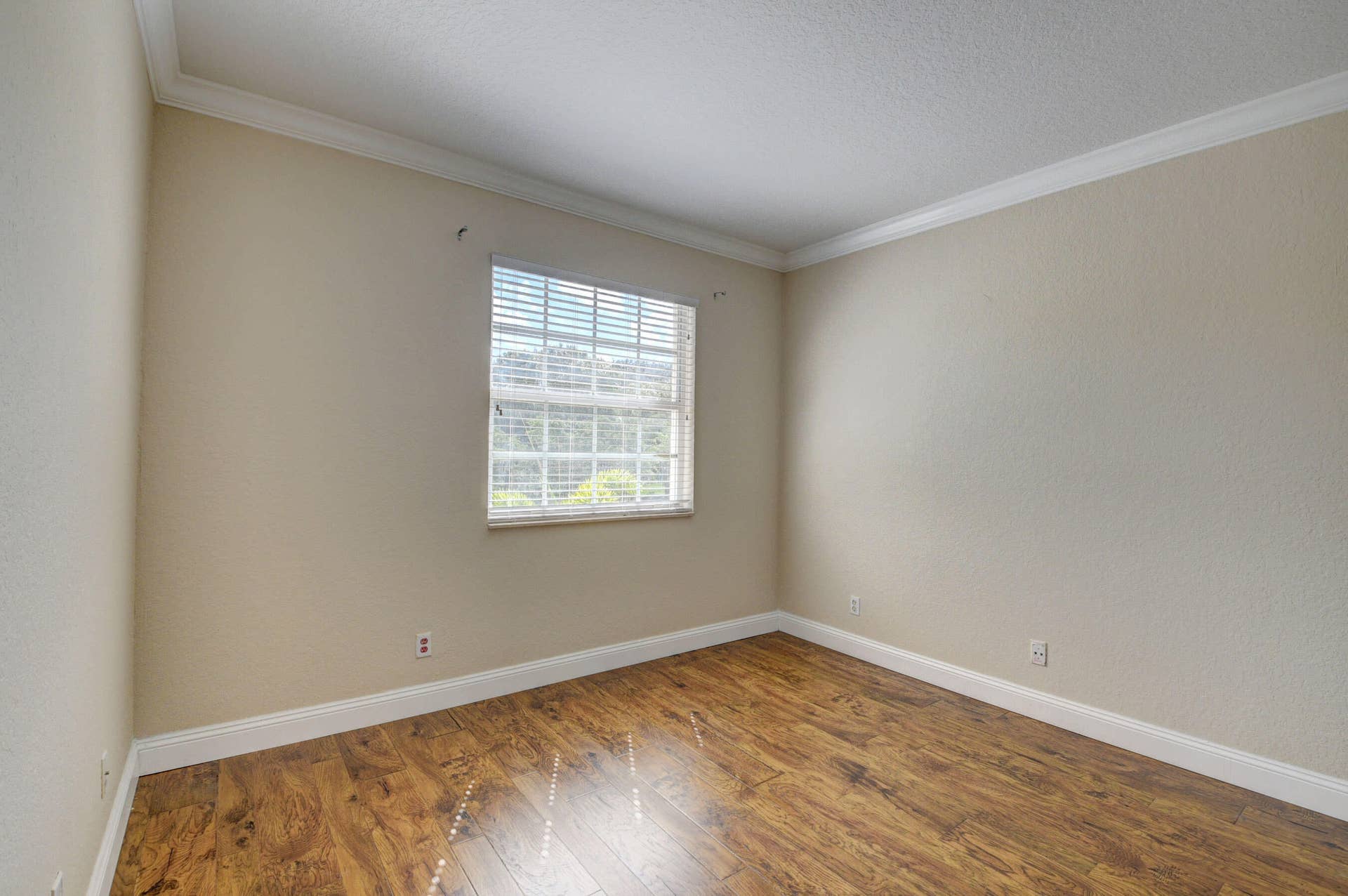 4353 Legacy Court, Delray Beach, FL 33445 Bedroom with window and wood-look flooring.