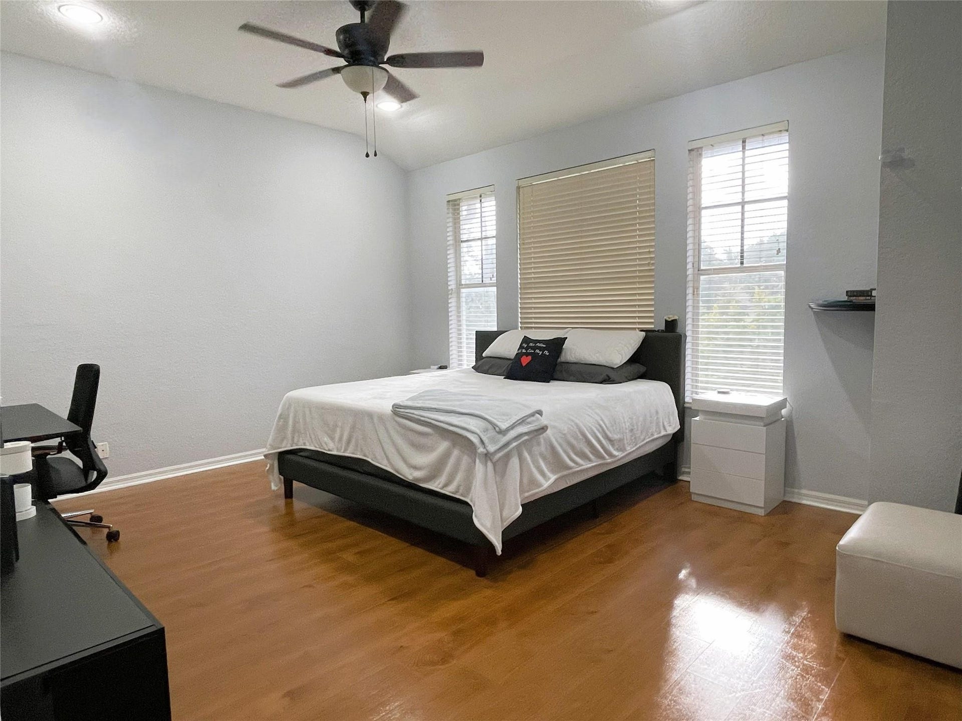 5780 NW 120TH Avenue, Coral Springs, Coral Springs, FL 33076 Room featuring vaulted ceilings, wood-finish flooring, a ceiling fan, and three windows with built-in blinds