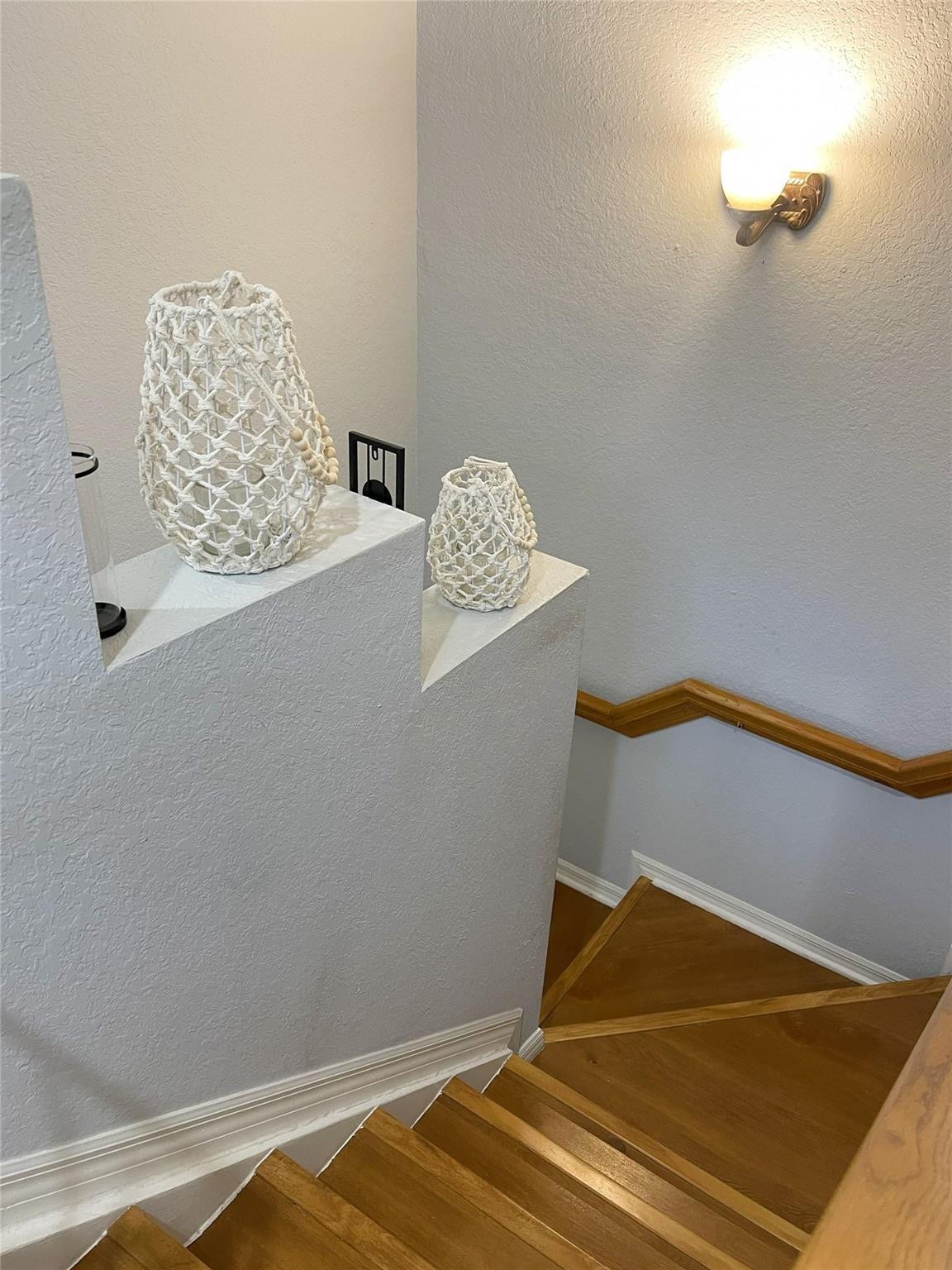 5780 NW 120TH Avenue, Coral Springs, Coral Springs, FL 33076 Staircase featuring wood treads, a wall-mounted wood handrail, and a wall-mounted light fixture