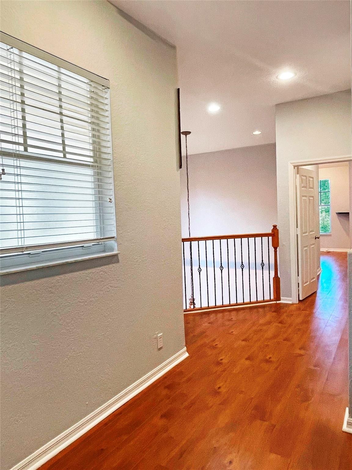 5780 NW 120TH Avenue, Coral Springs, Coral Springs, FL 33076 Interior space featuring wood-finish flooring, recessed lighting, and a metal balustrade railing