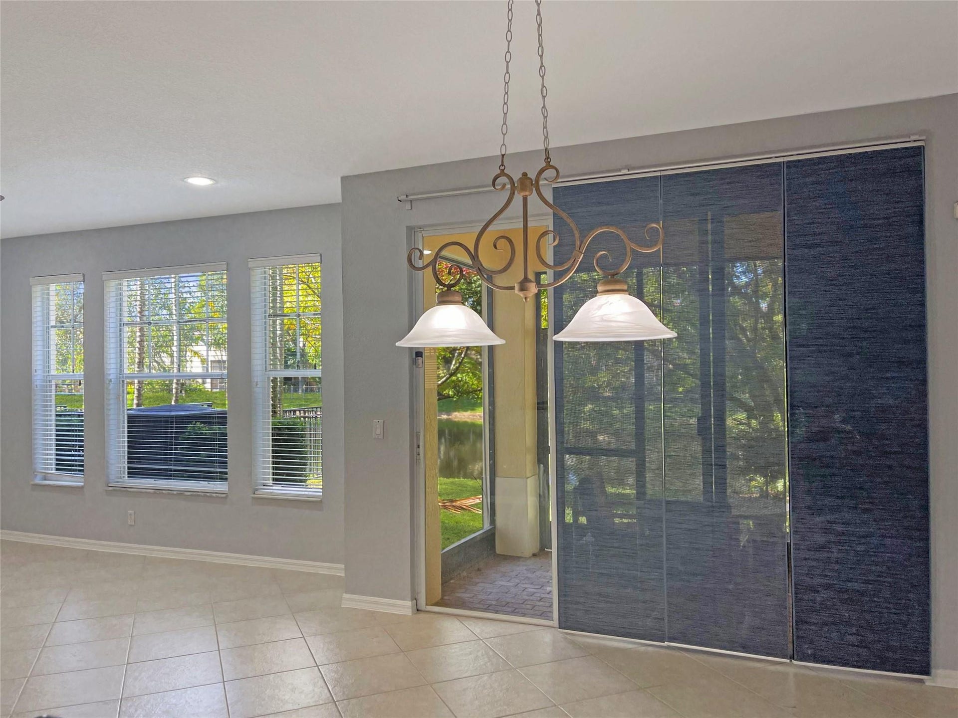 5780 NW 120TH Avenue, Coral Springs, Coral Springs, FL 33076 Tile flooring, multi-pane windows, recessed ceiling lighting, decorative dual-bulb pendant fixture, and sliding glass panel doors