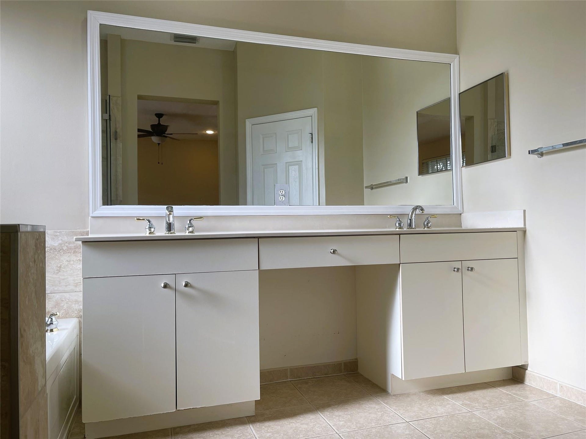 5780 NW 120TH Avenue, Coral Springs, Coral Springs, FL 33076 Dual-sink vanity with white cabinetry, light-toned countertop, and expansive framed wall mirror