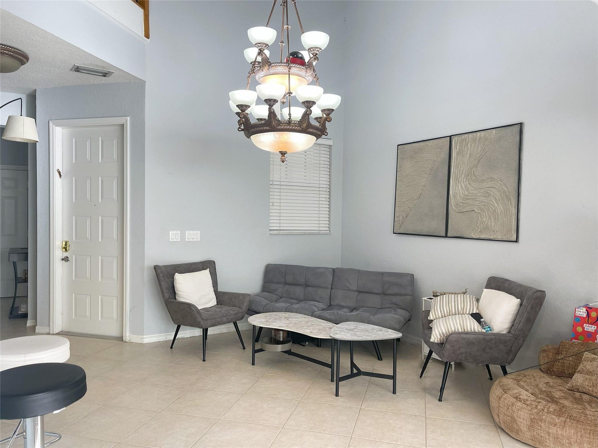 5780 NW 120TH Avenue, Coral Springs, Coral Springs, FL 33076 High-ceiling interior featuring tile flooring, a multi-tiered traditional chandelier, and a neutral color palette