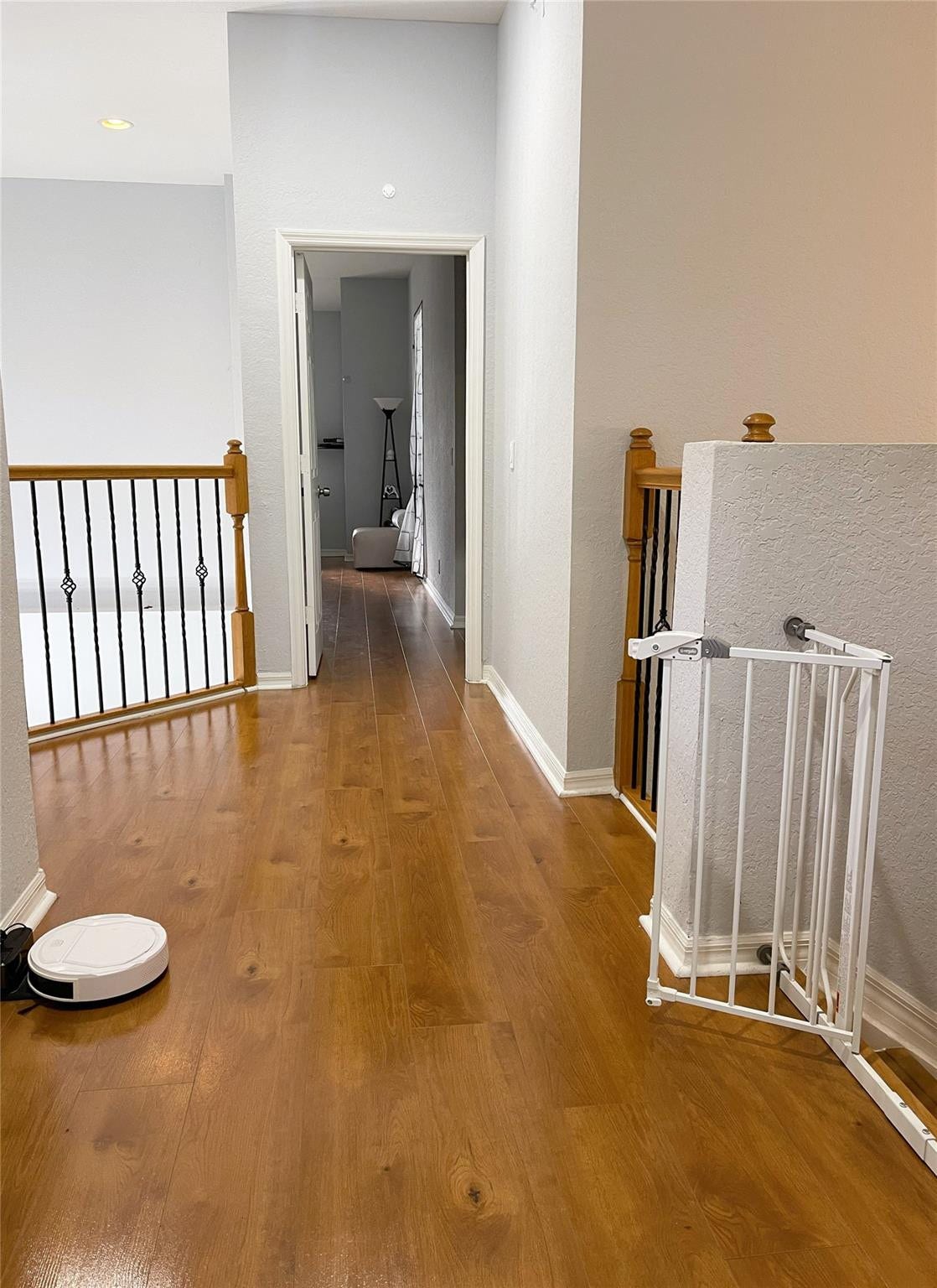 5780 NW 120TH Avenue, Coral Springs, Coral Springs, FL 33076 Wood-finish flooring throughout, featuring a staircase railing with wood-capped banisters and black metal balusters