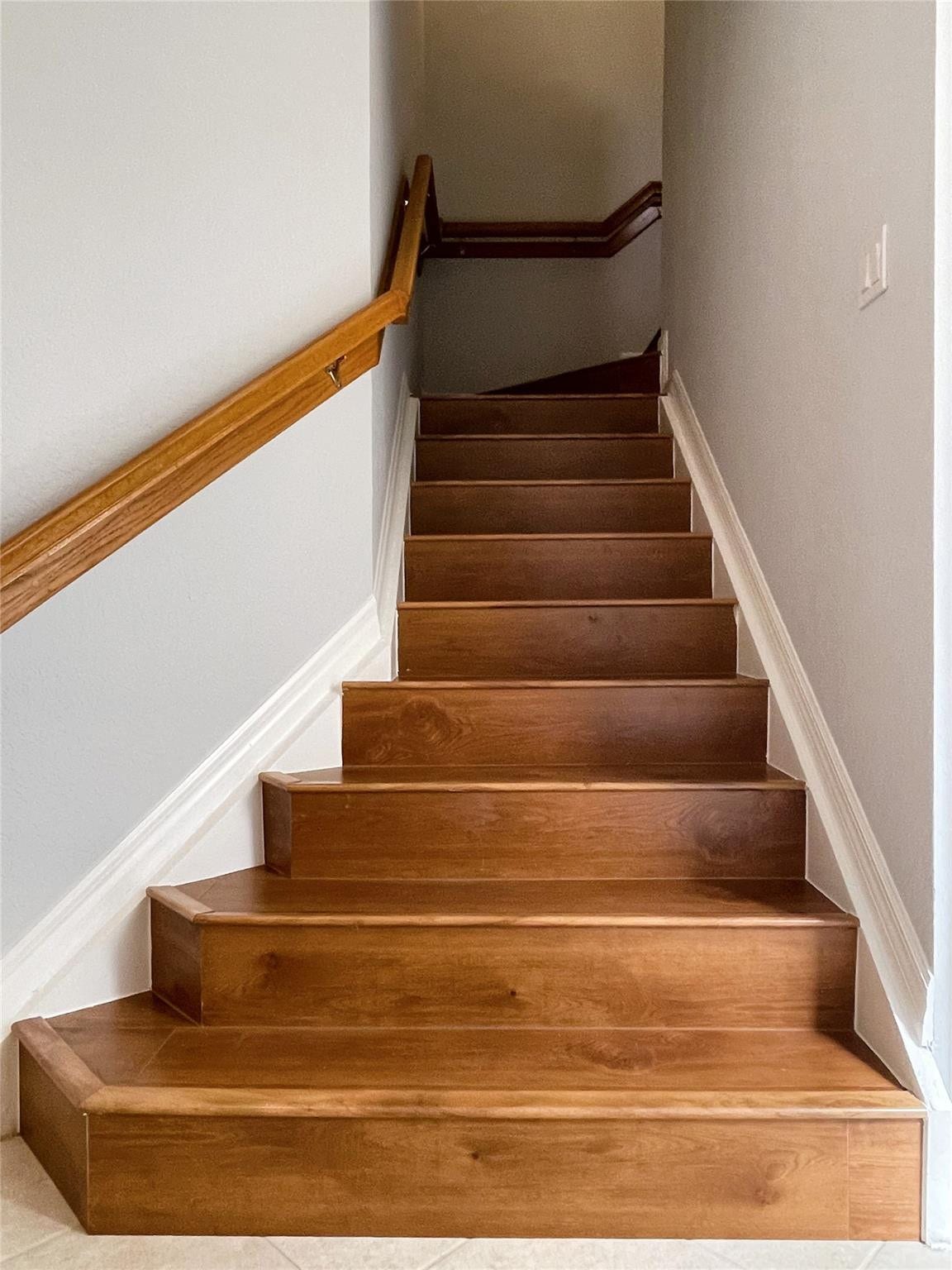 5780 NW 120TH Avenue, Coral Springs, Coral Springs, FL 33076 Staircase featuring wood treads and a wall-mounted wooden handrail