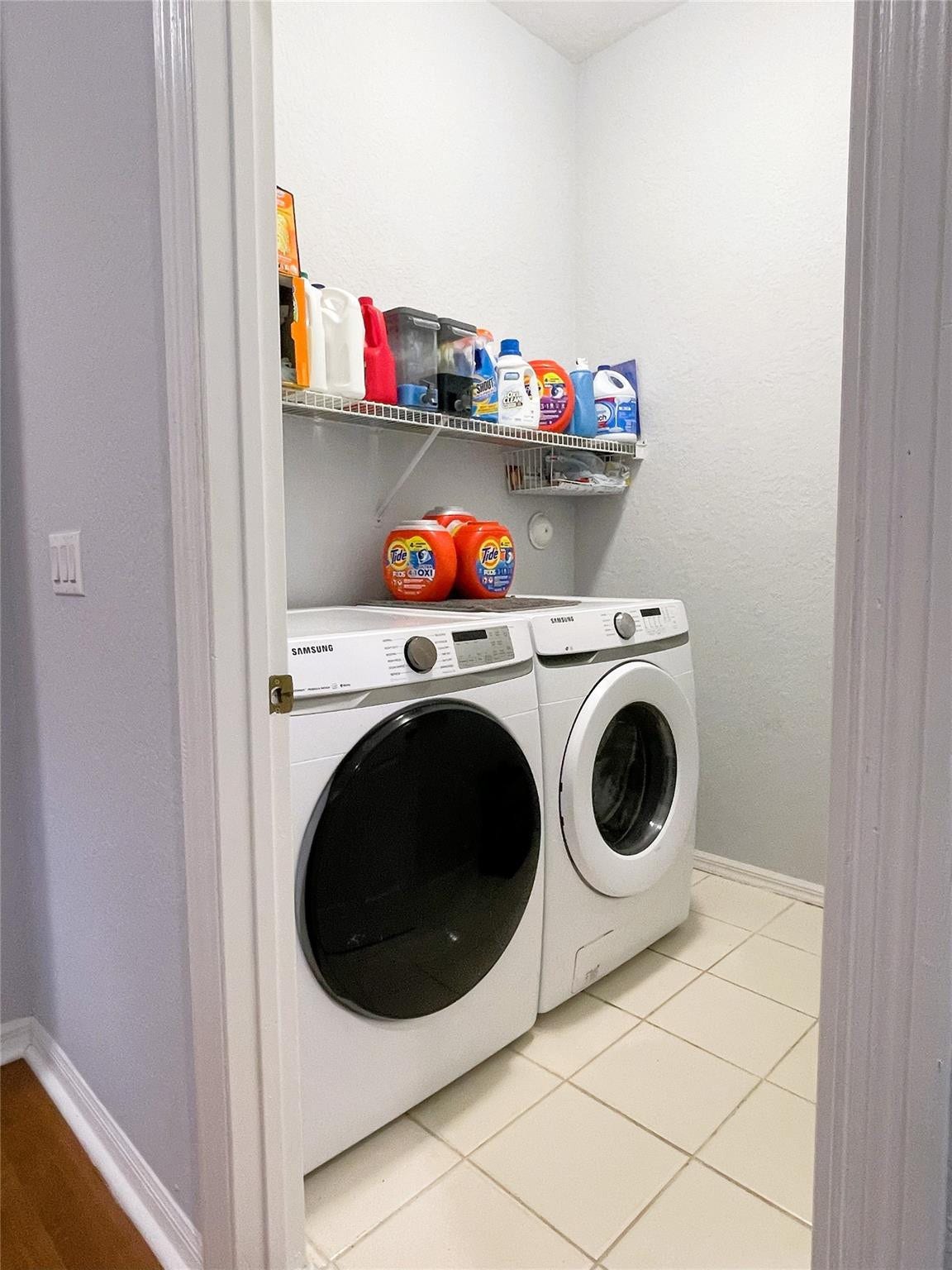 5780 NW 120TH Avenue, Coral Springs, Coral Springs, FL 33076 Laundry area featuring tile flooring and a wall-mounted wire shelving unit