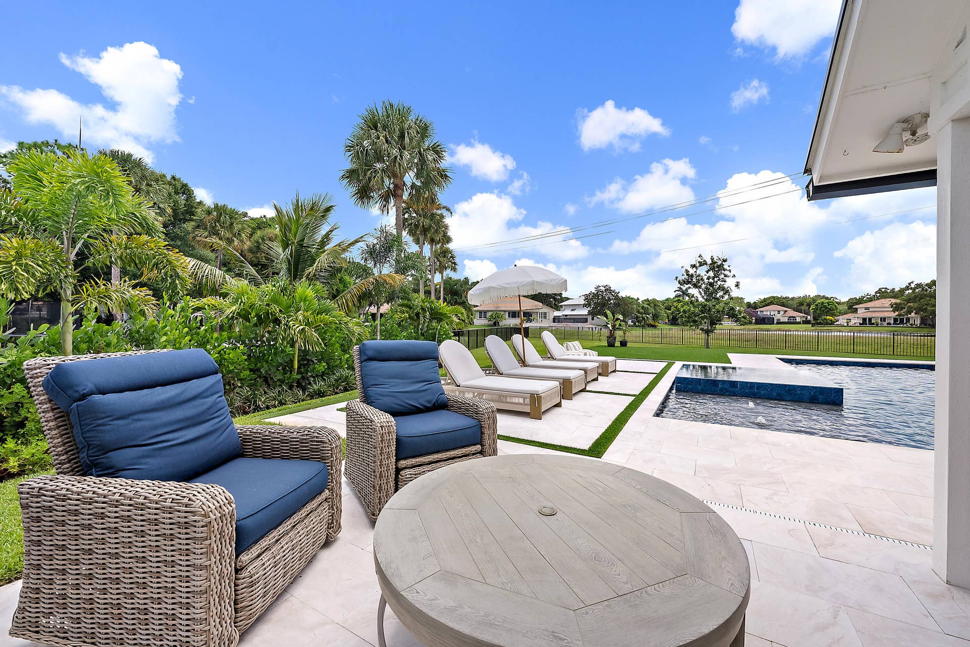 6204 SAND PINE Court, Jupiter, Jupiter, FL 33458 Expansive outdoor living area featuring a pool with water features, a spacious patio, and a manicured lawn