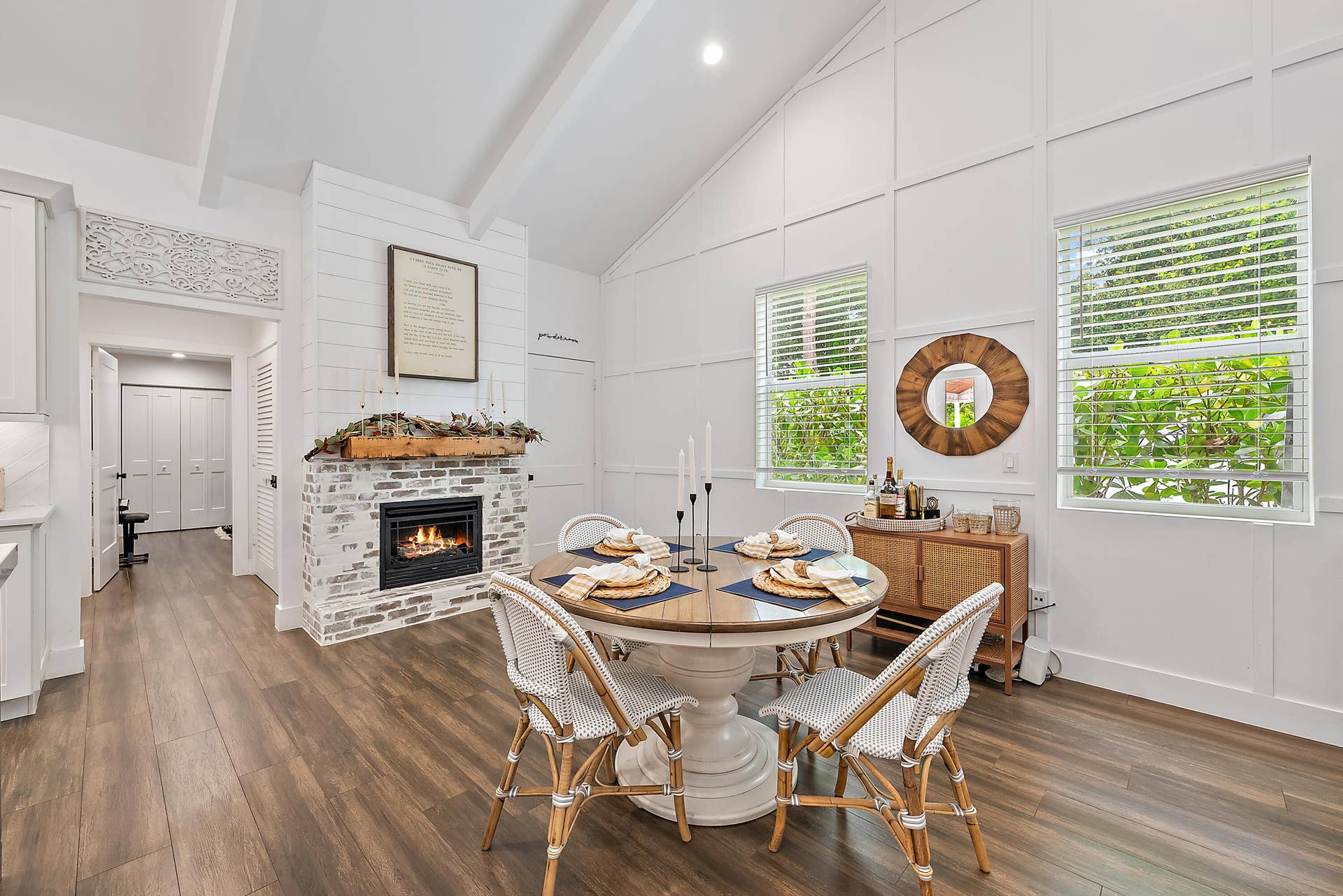 6204 SAND PINE Court, Jupiter, Jupiter, FL 33458 Wood-finish flooring, vaulted ceiling with exposed beams, white brick fireplace with a wood mantle, and multiple windows
