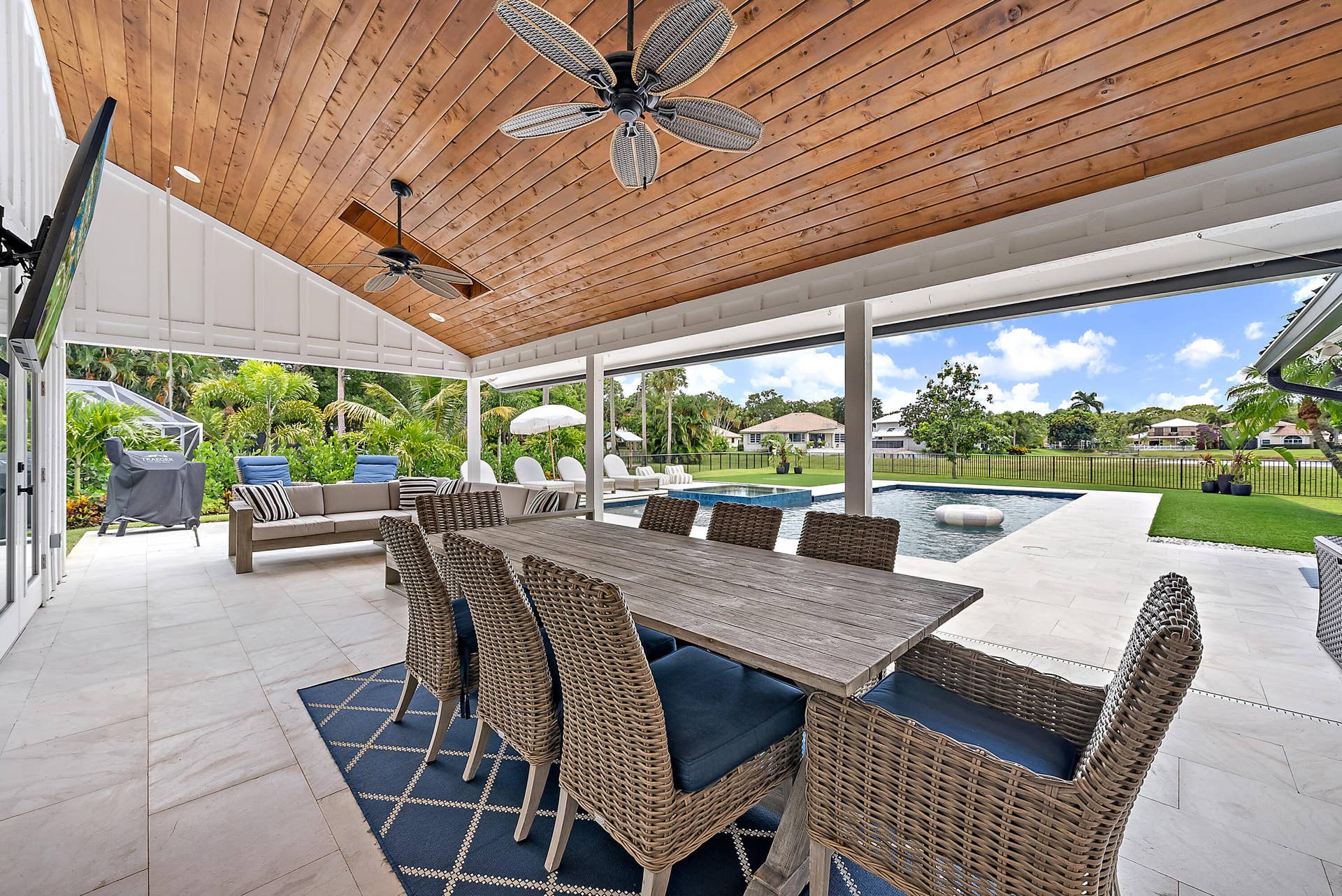 6204 SAND PINE Court, Jupiter, Jupiter, FL 33458 Covered patio with a natural wood-finish vaulted ceiling and integrated ceiling fans