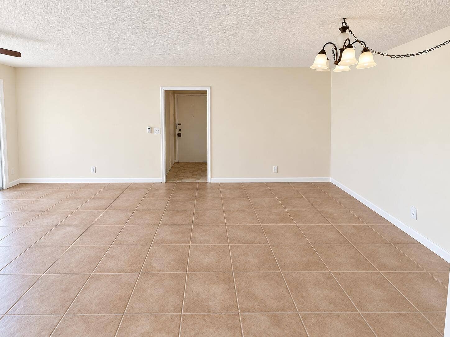 Boca Raton, Boca Raton, FL 33428 Empty Cream-Tiled Room with Chandelier