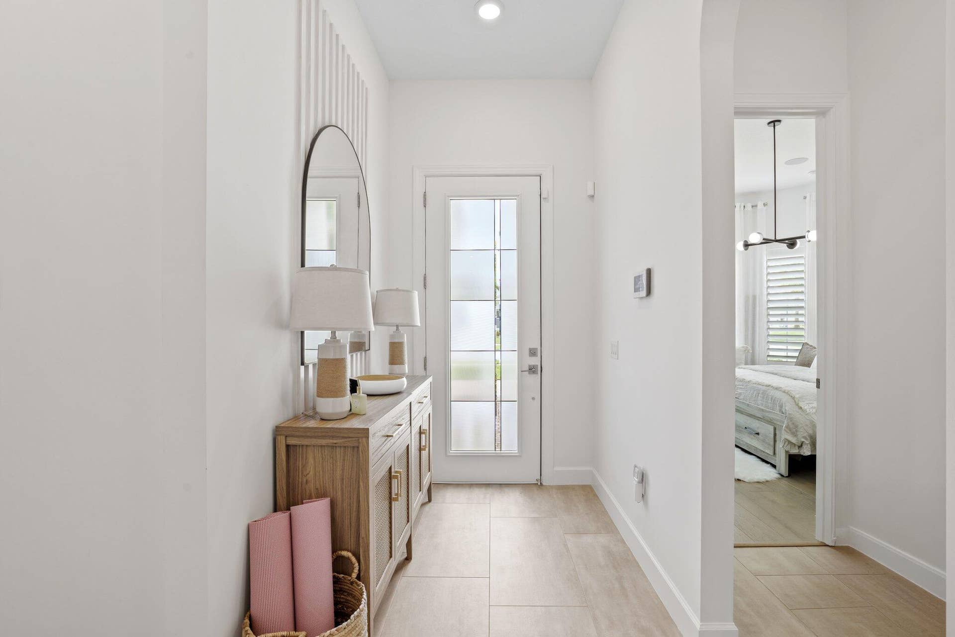 205 GEILLIS Path, Delray Beach, FL 33445 Entryway featuring large-format tile flooring, a glass-panel entry door, vertical wall paneling, and a recessed ceiling light