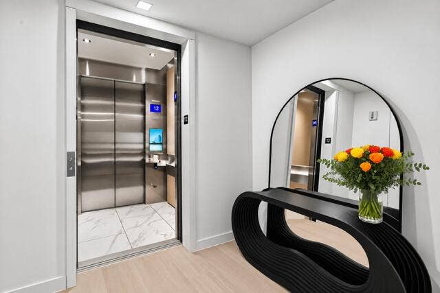 An elegant private elevator foyer welcomes you home with sophisticated architectural details and a striking designer console, setting the tone for luxury living.