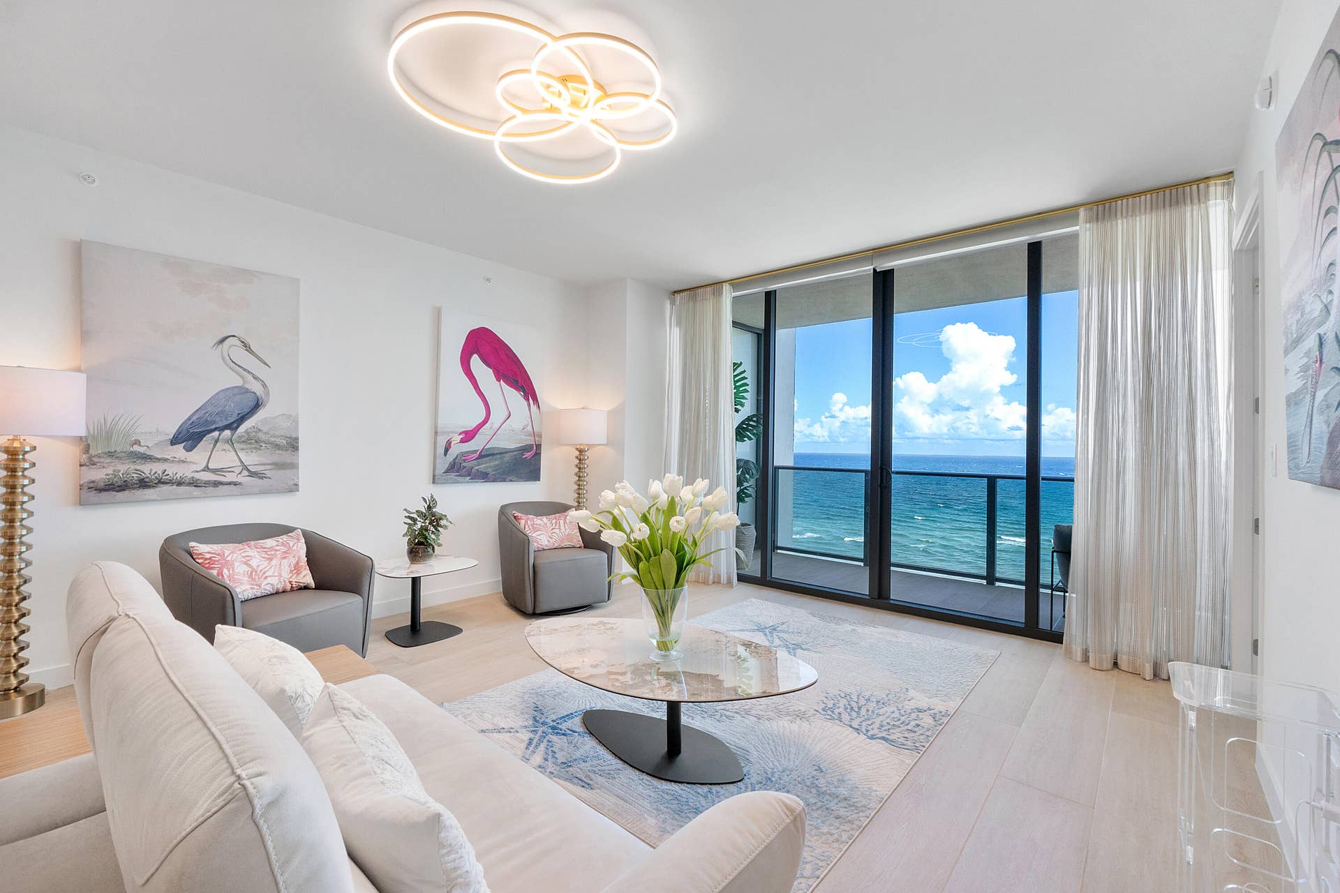 Sophisticated coastal living at its finest, featuring a beautifully appointed living room with modern designer furnishings and a warm, inviting atmosphere
